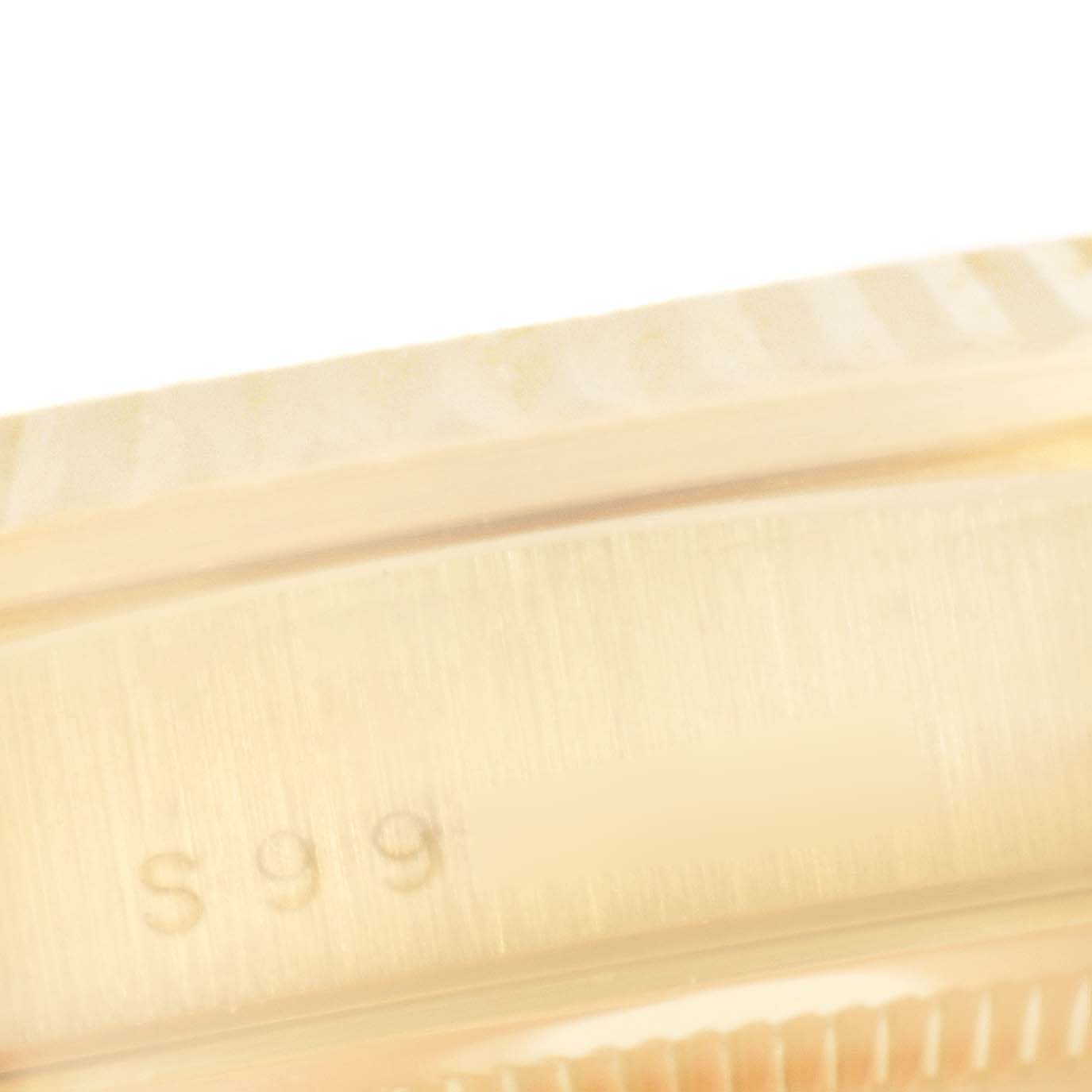 This close-up image shows part of the bezel and case side of a Rolex President 18238 Men's Yellow Gold Champagne Dial 18238 Men's Yellow Gold Champagne Dial watch with some engraved characters visible.