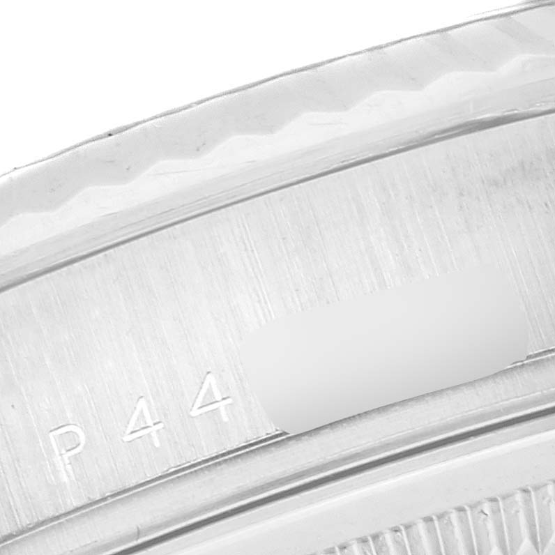 This close-up image of the Rolex President 118239 Men's White Gold Silver Dial 118239 Men's White Gold Silver Dial watch shows the edge of the bezel and part of the model identification engraving.