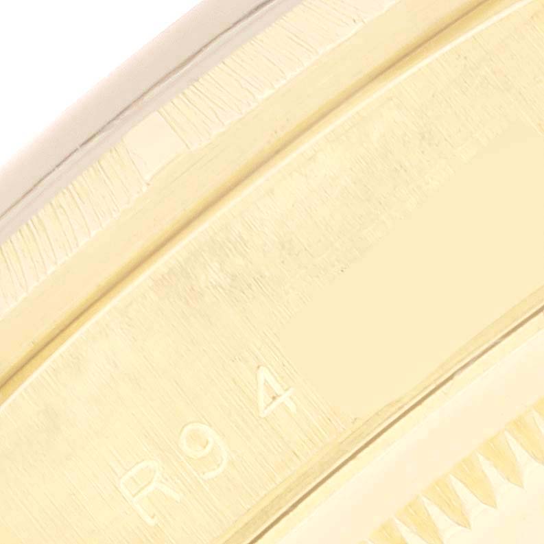 This close-up image shows the side of the case of a Rolex President 18248 Men's Yellow Gold Champagne Dial 18248 Men's Yellow Gold Champagne Dial model, focusing on the engraved serial number area.