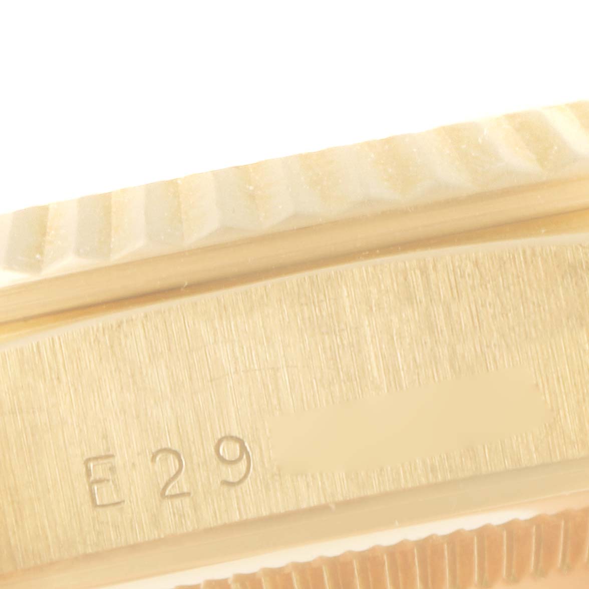 This close-up image shows the side view of the Rolex President 18238 Men
s Yellow Gold Champagne Dial 18238 Men
s Yellow Gold Champagne Dial model watch, focusing on its fluted bezel and serial number.