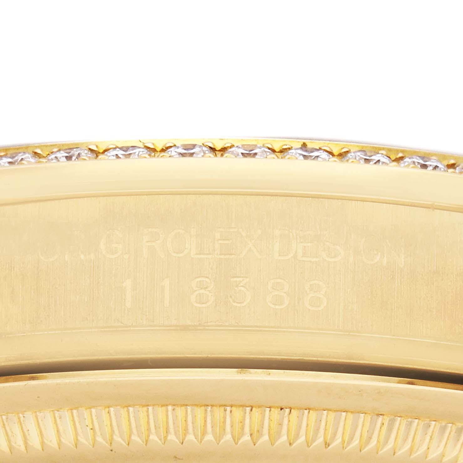 The image shows a close-up side view of a Rolex President 118388 Men
s Yellow Gold Mother of Pearl Dial model, highlighting the bezel and part of the case with engraved details.