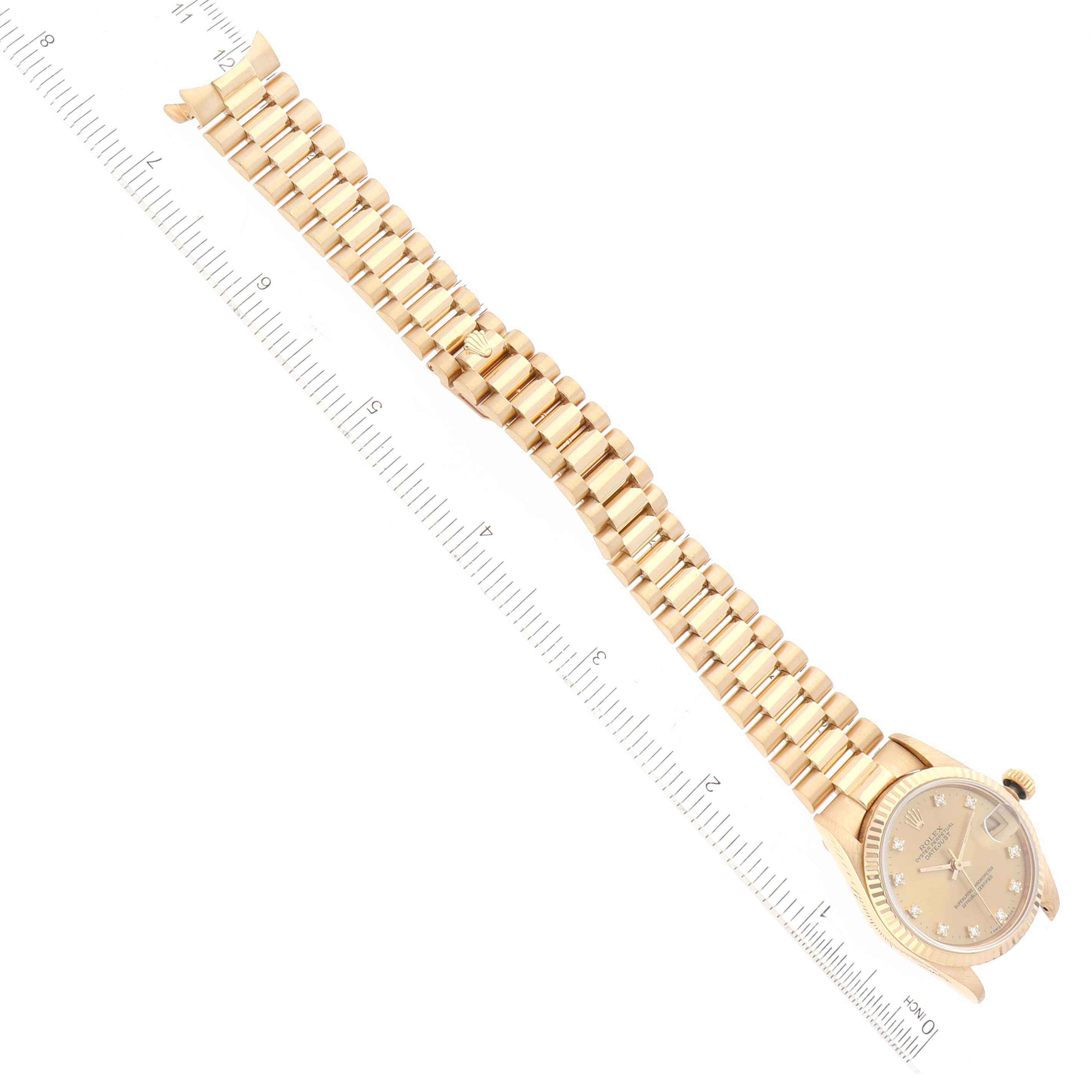 The image shows a top-down view of a Rolex President 68278 Women's Yellow Gold Champagne Dial 68278 Women's Yellow Gold Champagne Dial model watch in gold, with a ruler for scale.