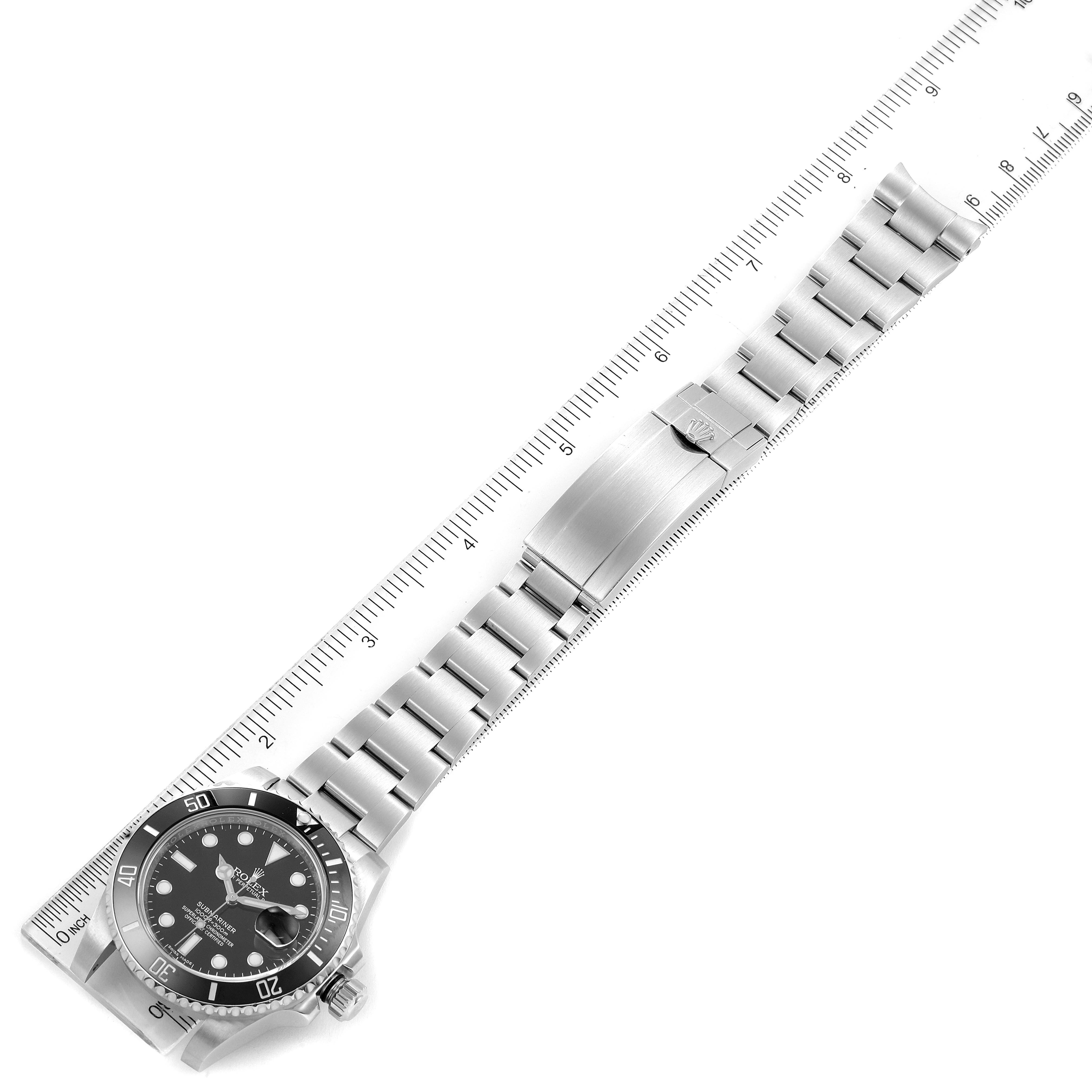 The image shows a top-down view of a Rolex Submariner 116610 Men's Stainless Steel Black Dial 116610 Men's Stainless Steel Black Dial watch, with the face, bezel, and full bracelet visible, alongside a ruler.