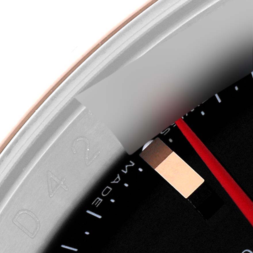 This close-up image of a Rolex Turn-o-Graph 116261 Men's Steel and Gold (two tone) Black Dial 116261 Men's Steel and Gold (two tone) Black Dial watch shows the bezel, part of the dial, and detail of the minute markers.