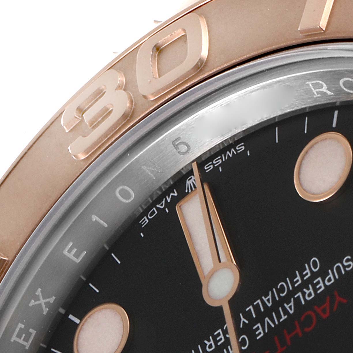 This close-up angle of the Rolex Yacht-Master 126621 Men's Steel and Gold (two tone) Black Dial 126621 Men's Steel and Gold (two tone) Black Dial watch shows part of the bezel, dial, and hour hand.