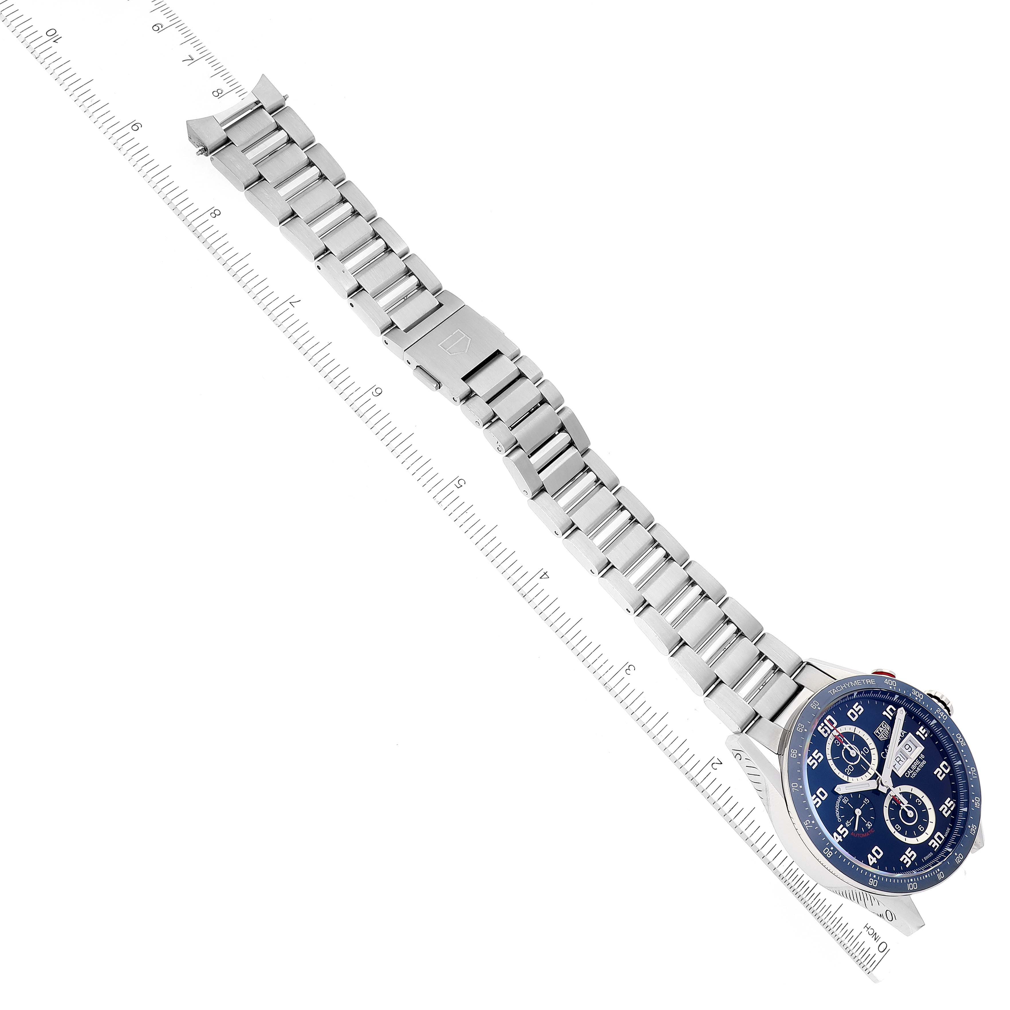 This image shows a Tag Heuer Carrera CV2A1V.BA0738 Men's Stainless Steel Blue Dial CV2A1V.BA0738 Men's Stainless Steel Blue Dial watch at an angled top view, displaying its face and stainless steel bracelet with a ruler for scale.