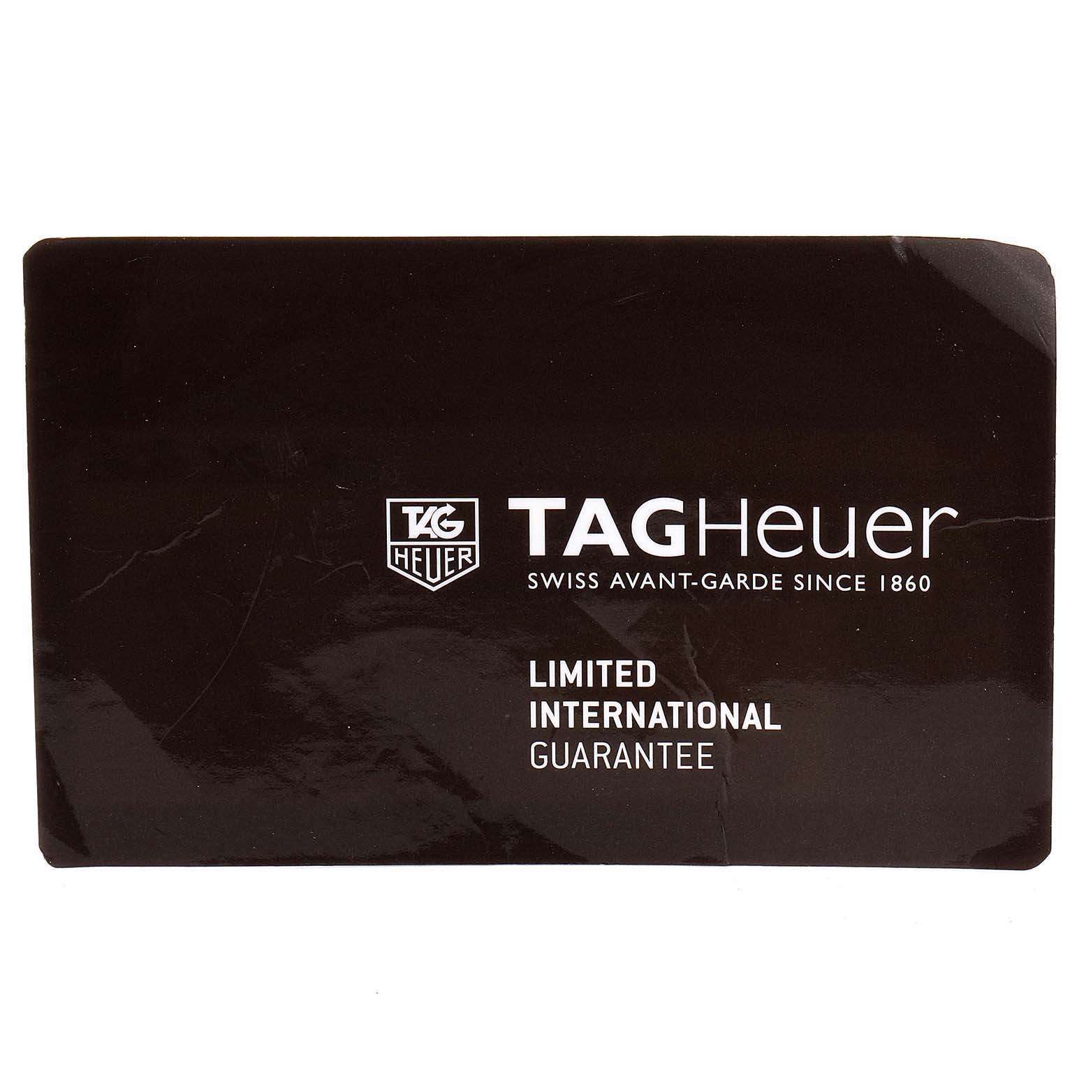 The image shows a TAG Heuer limited international guarantee card for the Carrera model watch.