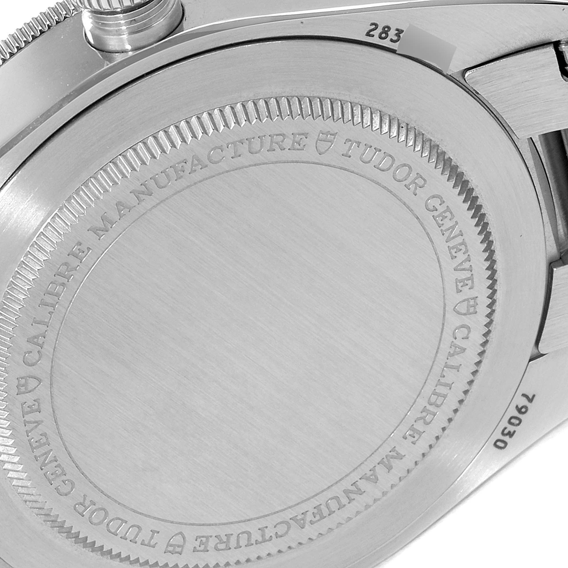 The image shows the case back of the Tudor Heritage Black Bay 79030N Men's Stainless Steel Black Dial 79030N Men's Stainless Steel Black Dial watch, featuring its engraved details and part of the bracelet.