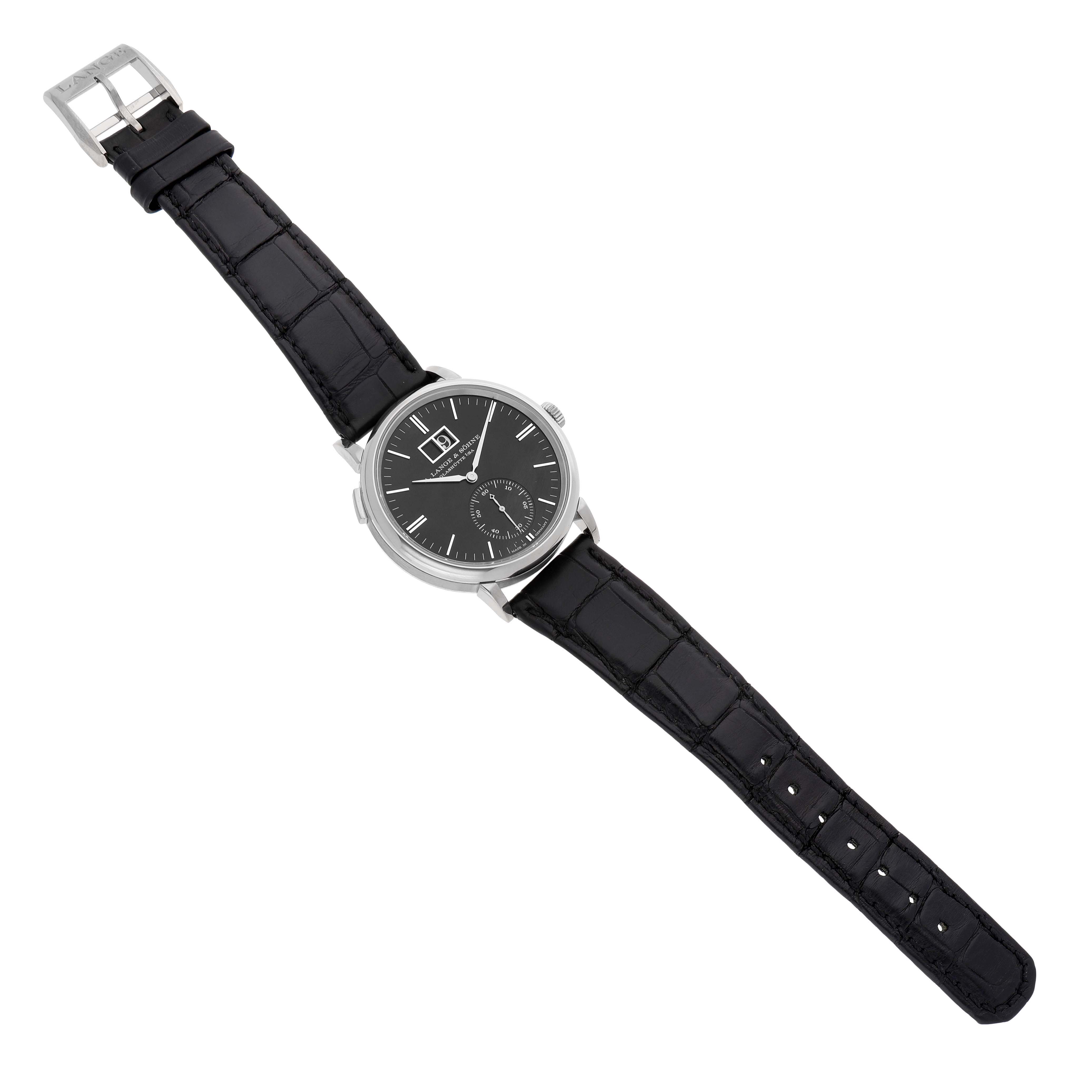 The A. Lange & Sohne Saxonia 381.029 / LSLS3813AD Men's White Gold Black Dial watch is shown at a slight angle, displaying the black dial, hands, indices, and leather strap with a buckle.