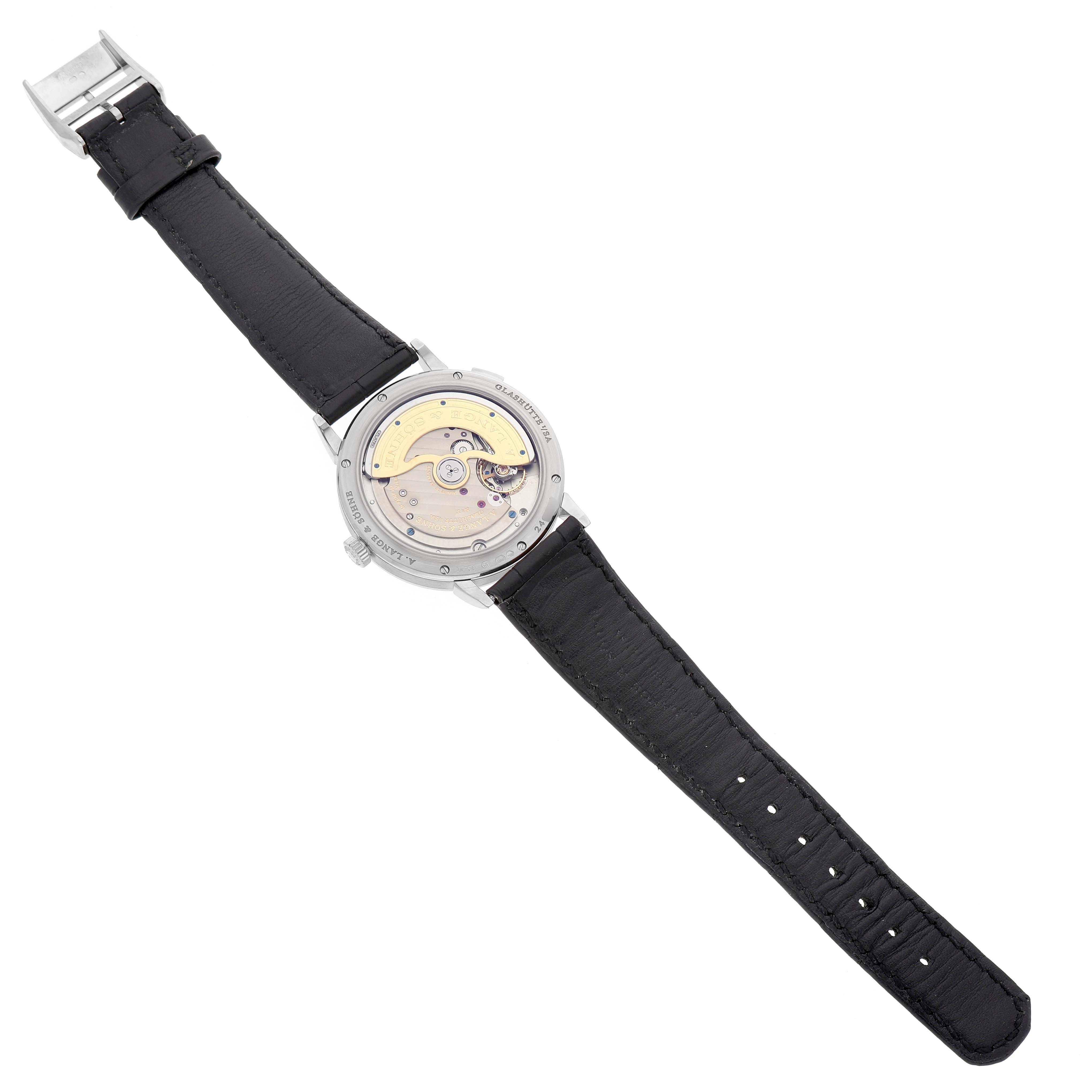 The image shows the back of the Saxonia model by A. Lange & Söhne, highlighting its intricate movement and leather strap.