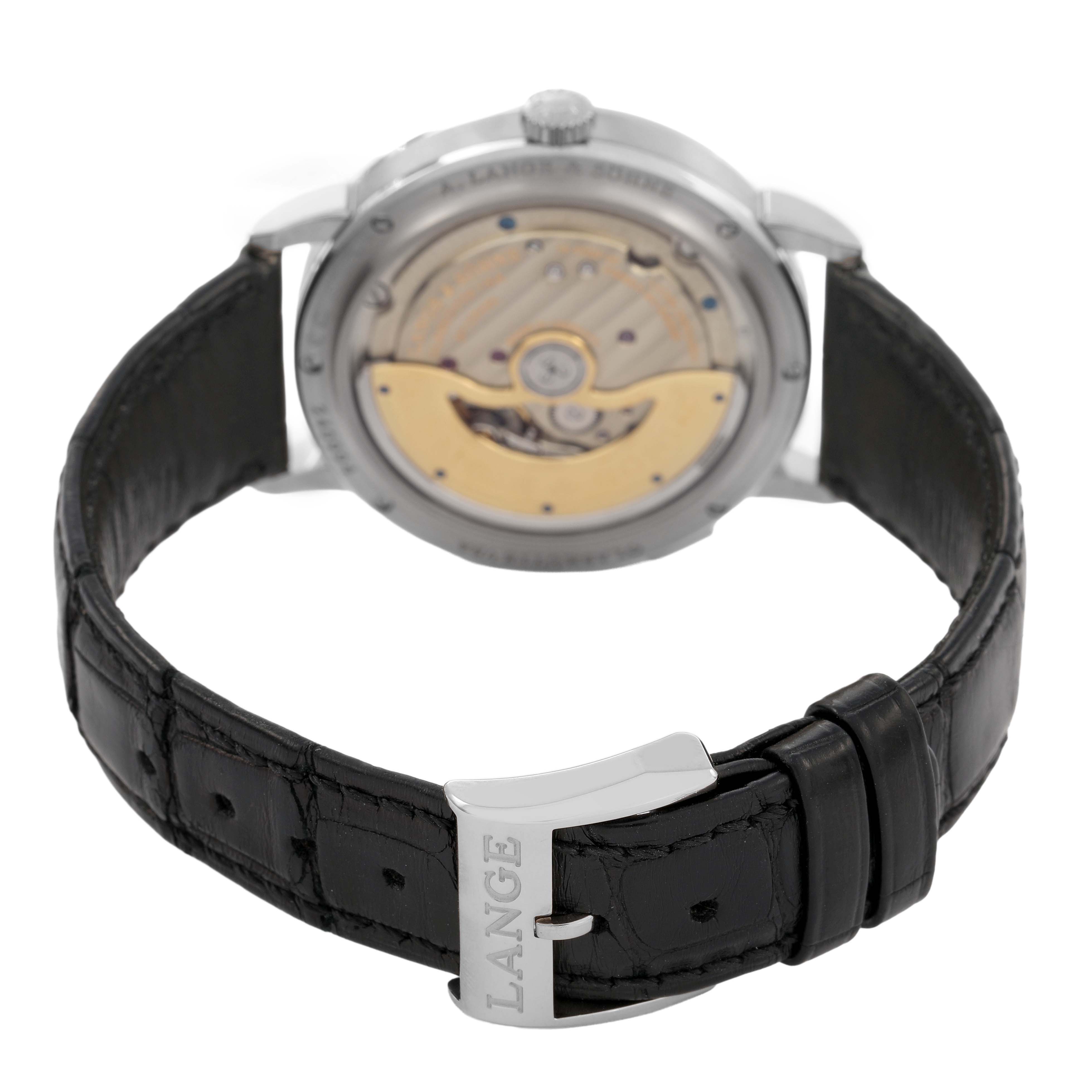 The image shows the back view of the A. Lange & Sohne Saxonia 381.029 / LSLS3813AD Men's White Gold Black Dial model, highlighting the movement and the buckle marked "LANGE."