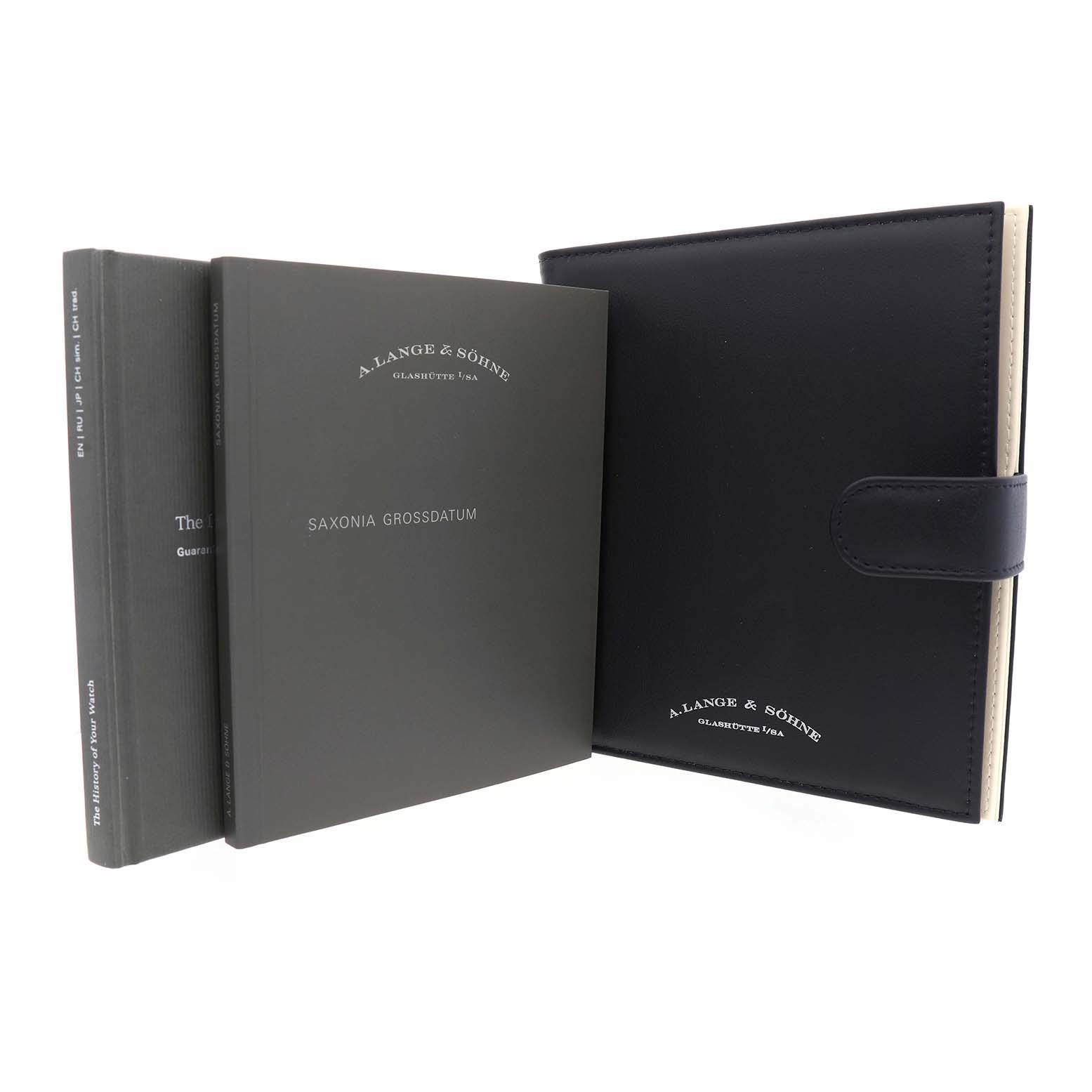 The image shows the A. Lange & Sohne Saxonia 381.029 / LSLS3813AD Men's White Gold Black Dial model's accessories with a booklet and a leather folder.