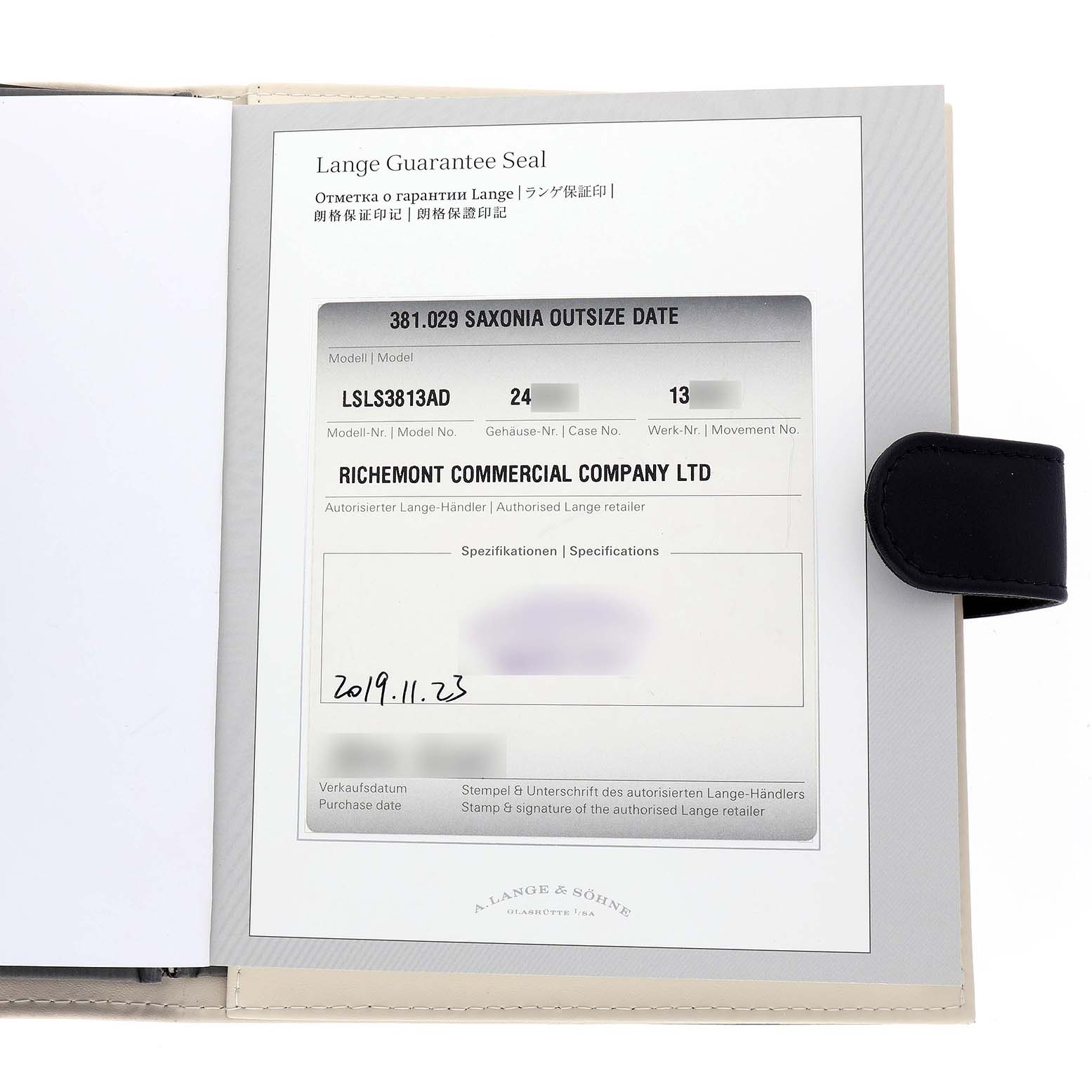 The image shows the A. Lange & Sohne Saxonia 381.029 / LSLS3813AD Men's White Gold Black Dial model's guarantee seal, displaying model and retailer details.
