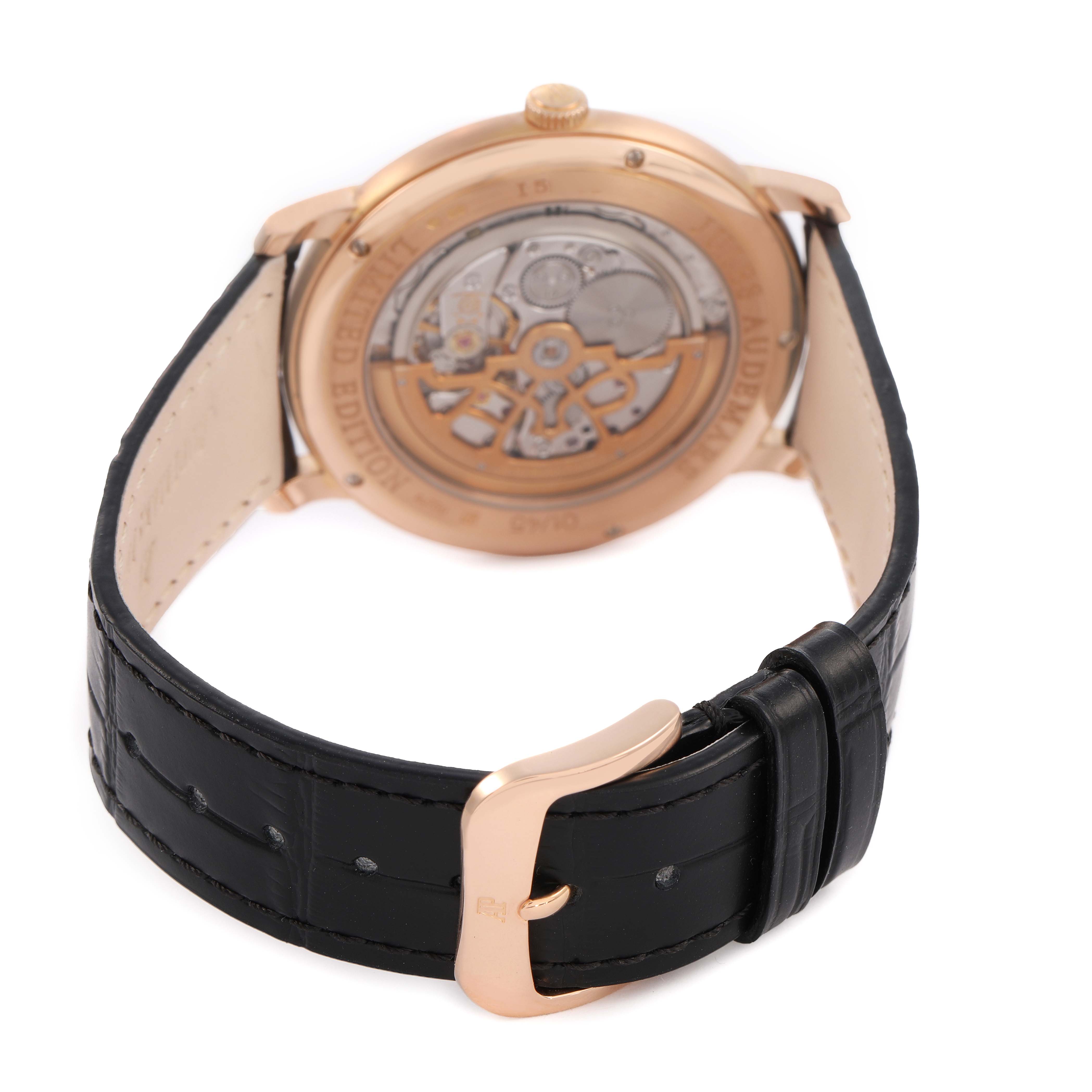 The Jules by Audemars Piguet is shown from the back, highlighting its exhibition case back and black leather strap with a gold buckle.