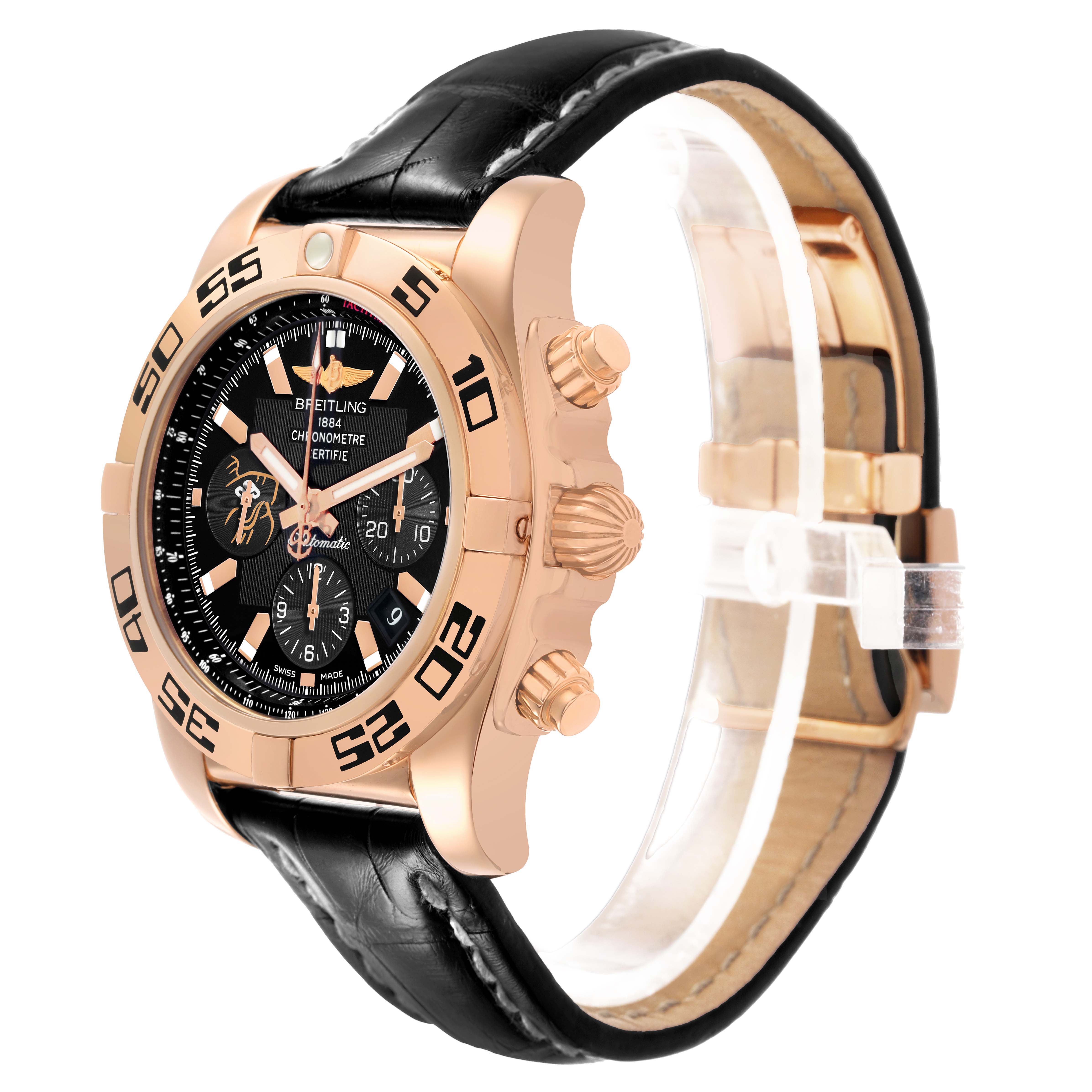 The Breitling Chronomat HB01115W/BE53 Men's Yellow Gold Black Dial watch is shown at a side angle, highlighting the crown, pushers, and black leather strap.