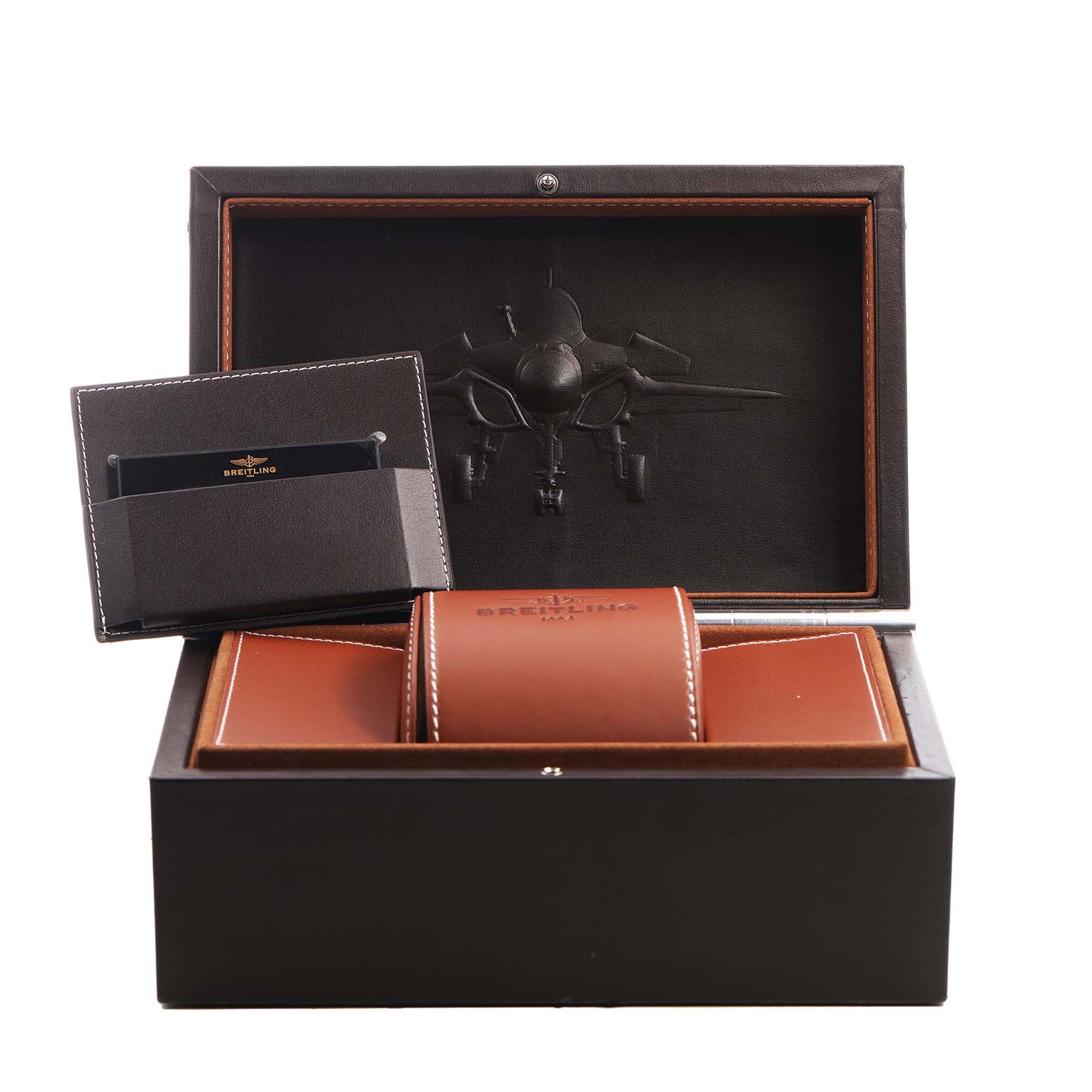 The image shows the Breitling Chronomat HB01115W/BE53 Men's Yellow Gold Black Dial's open box with a leather case, cardholder, and an embossed jet design inside.
