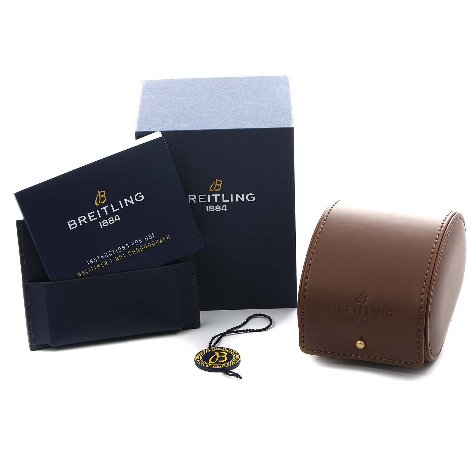 The image shows accessories for the Breitling Navitimer AB0121 Men
s Stainless Steel Black Dial, including a box, manual, leather case, and hang tag, viewed from an angle.