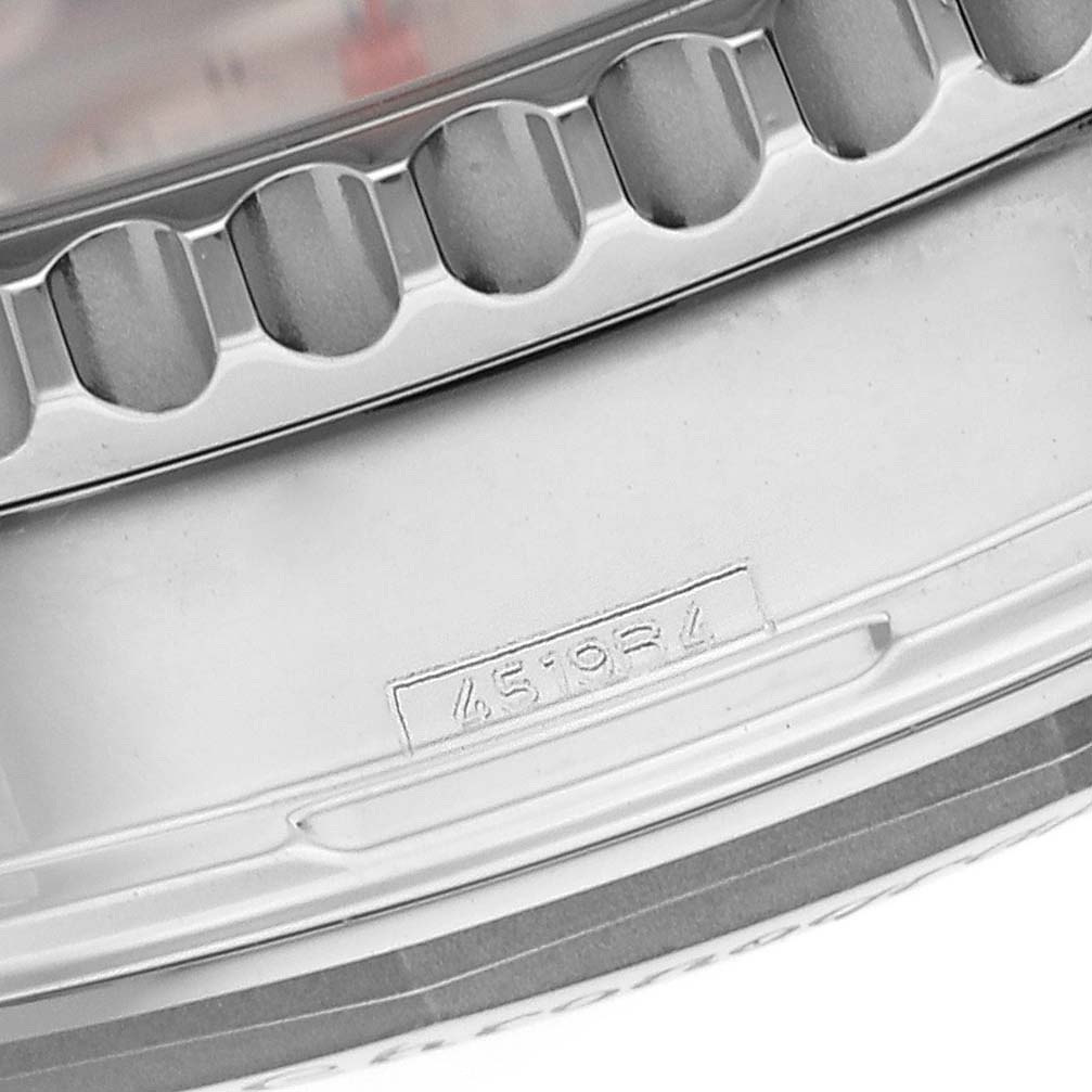 The image shows a close-up of the engraved bezel and part of the casing of a Breitling Navitimer AB0121 Men
s Stainless Steel Black Dial watch.