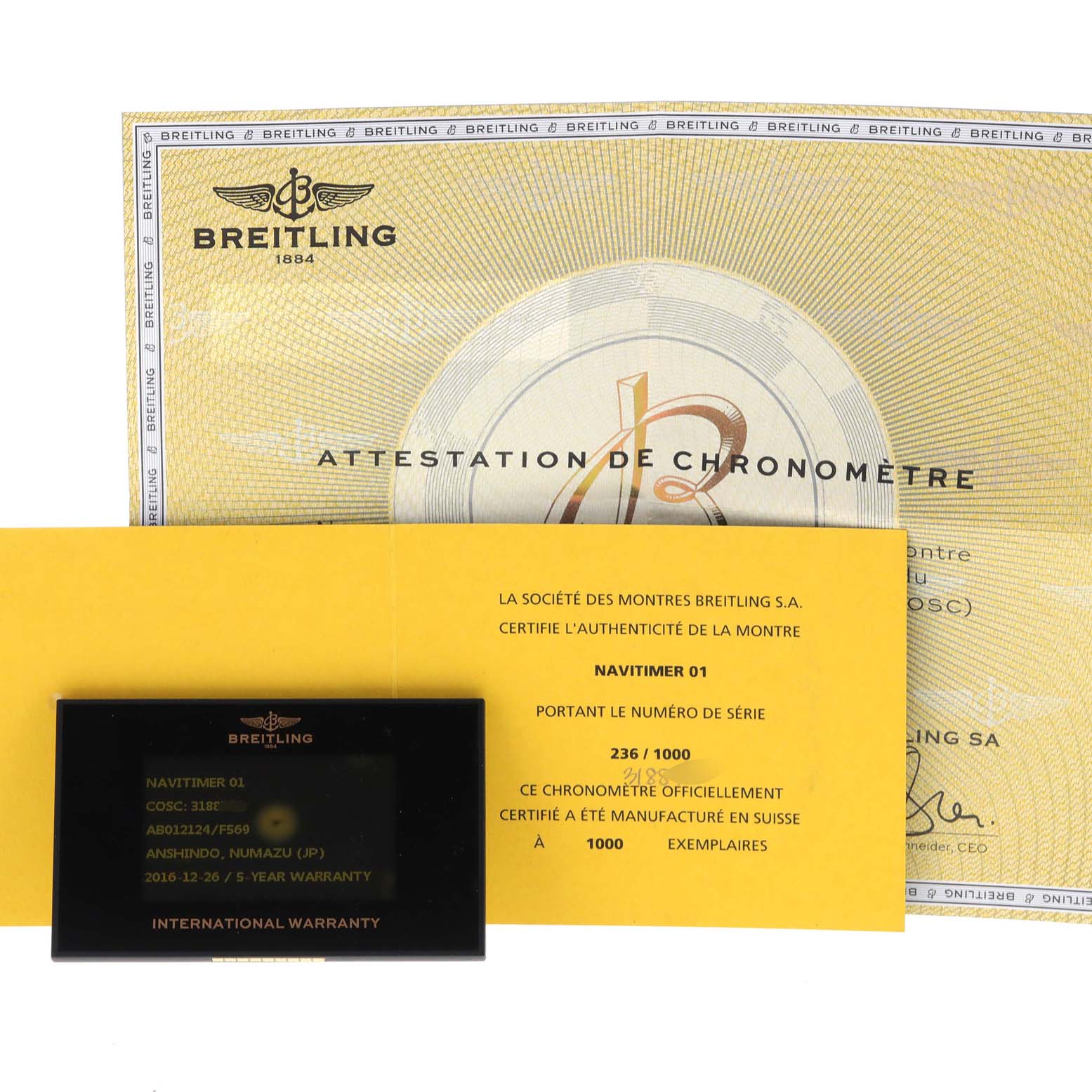 The image shows the warranty card and certificates for the Breitling Navitimer AB0121 Men's Stainless Steel Grey Dial AB0121 Men's Stainless Steel Grey Dial model from a top-down angle.