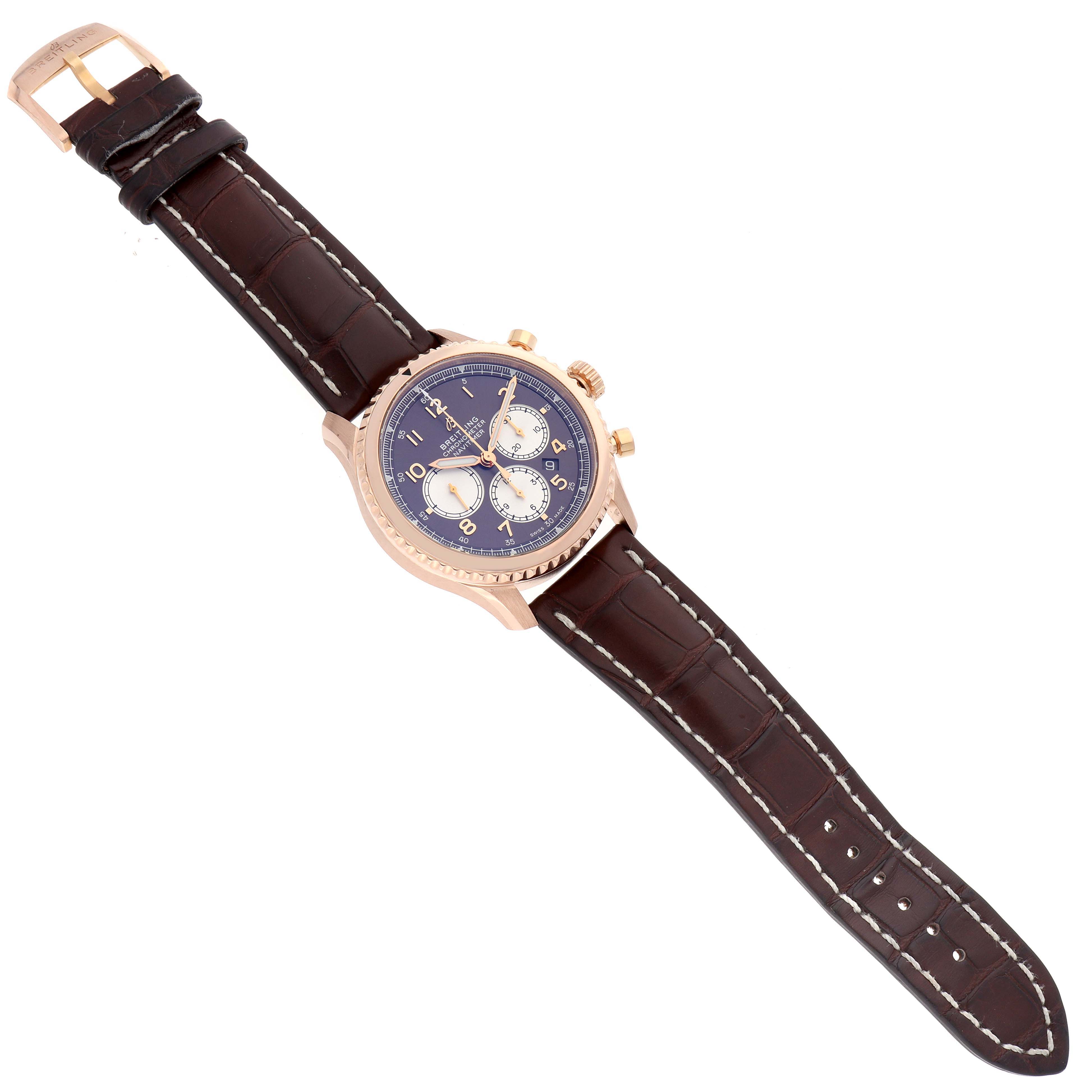 The Breitling Navitimer RB0117 Men
s Rose Gold Brown Dial is shown from a top-down angle, displaying the watch face, leather strap, and buckle.