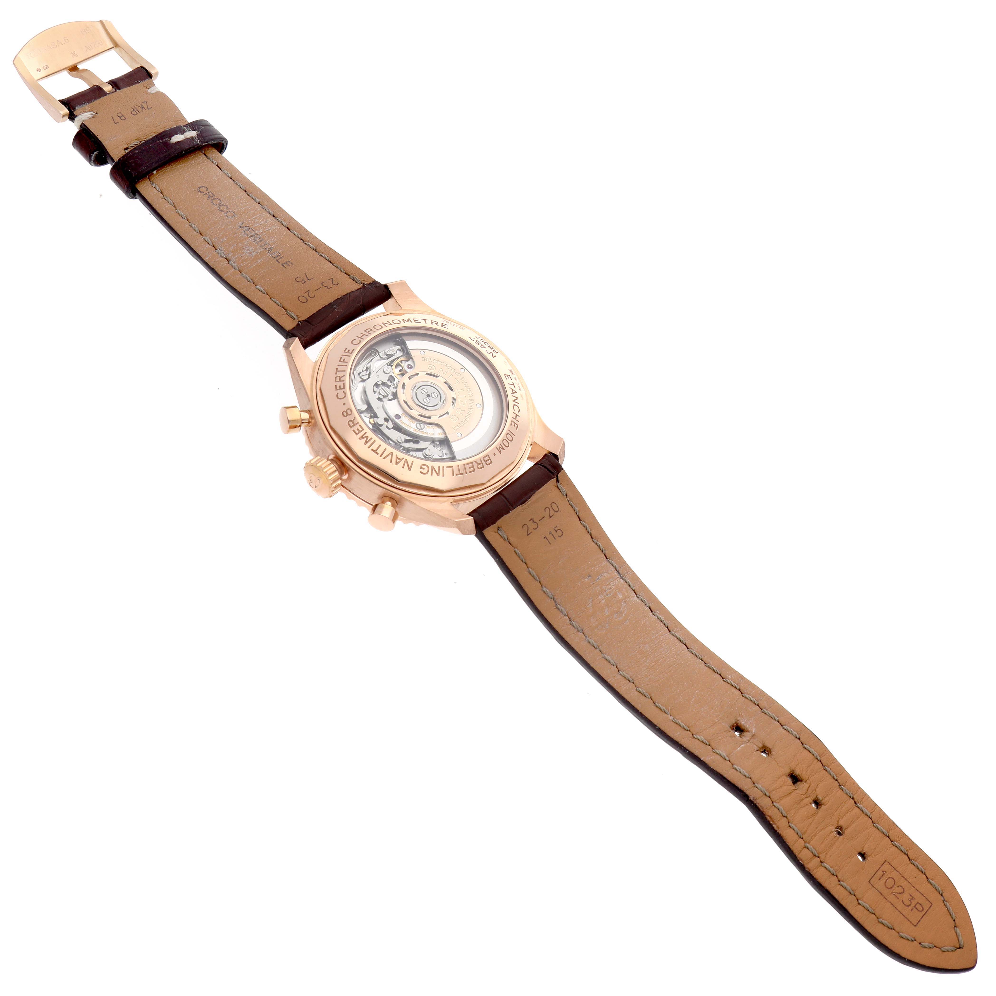 The Breitling Navitimer RB0117 Men
s Rose Gold Brown Dial watch is shown from the back, displaying its transparent case back and leather strap.