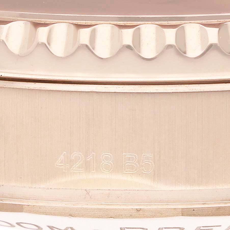 The image shows a close-up of the engraving on the side of a Breitling Navitimer RB0117 Men
s Rose Gold Brown Dial watch case.