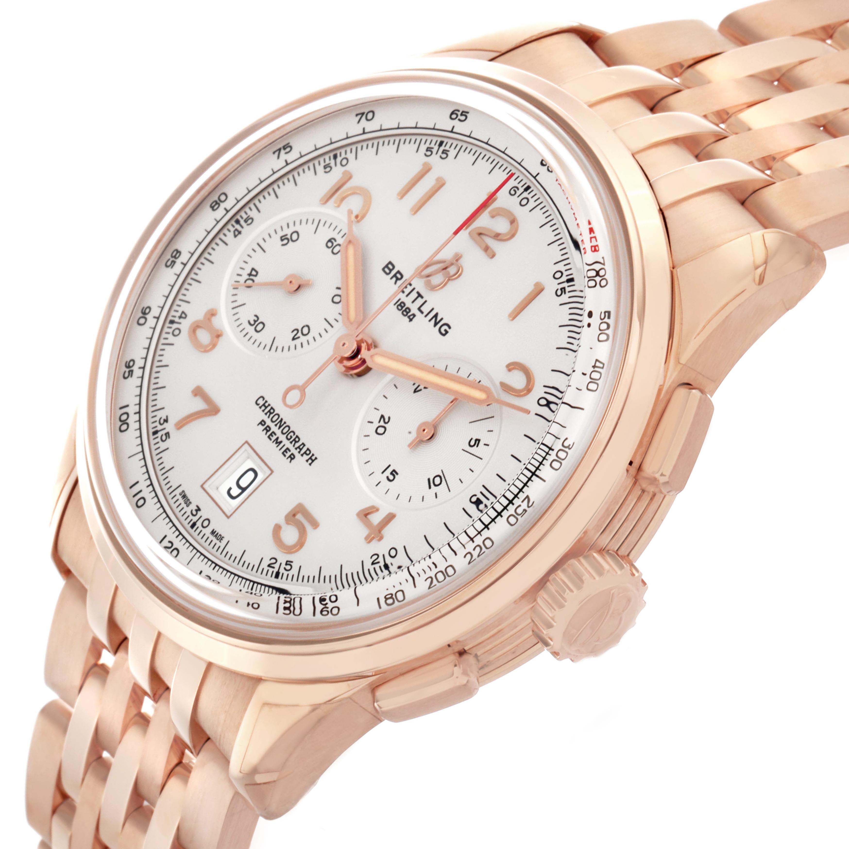 The Breitling Premier RB0145 Men
s Rose Gold White Dial watch is shown at an angled side view, displaying the face, chronograph dials, crown, and bracelet.