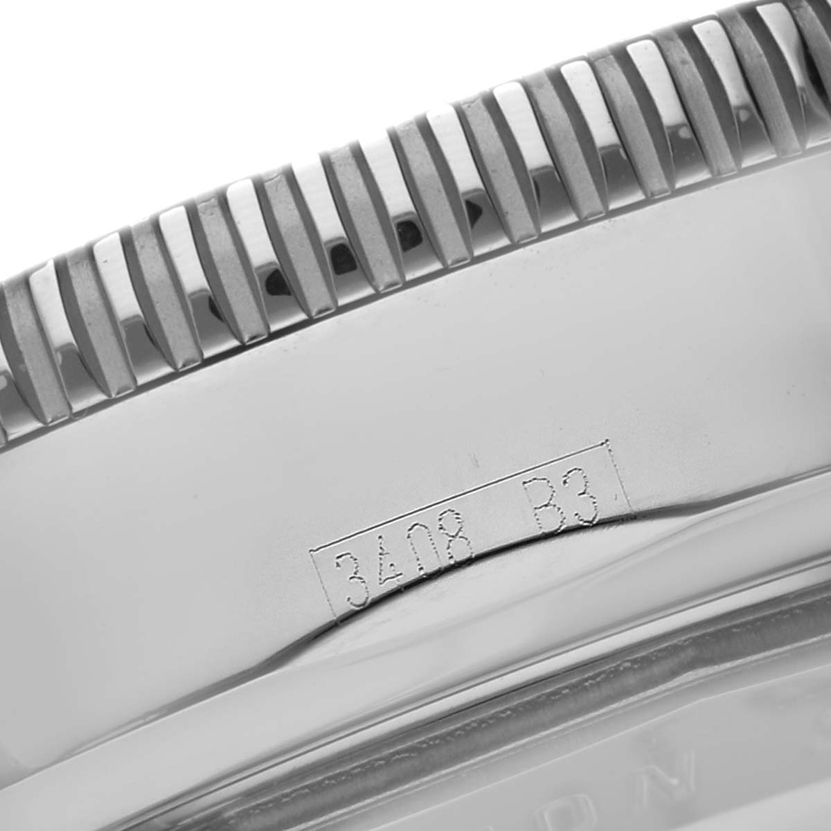 The image shows a close-up of the side of a Breitling Superocean A17320 Men
s Stainless Steel Brown Dial watch, focusing on the bezel and engraved serial number.