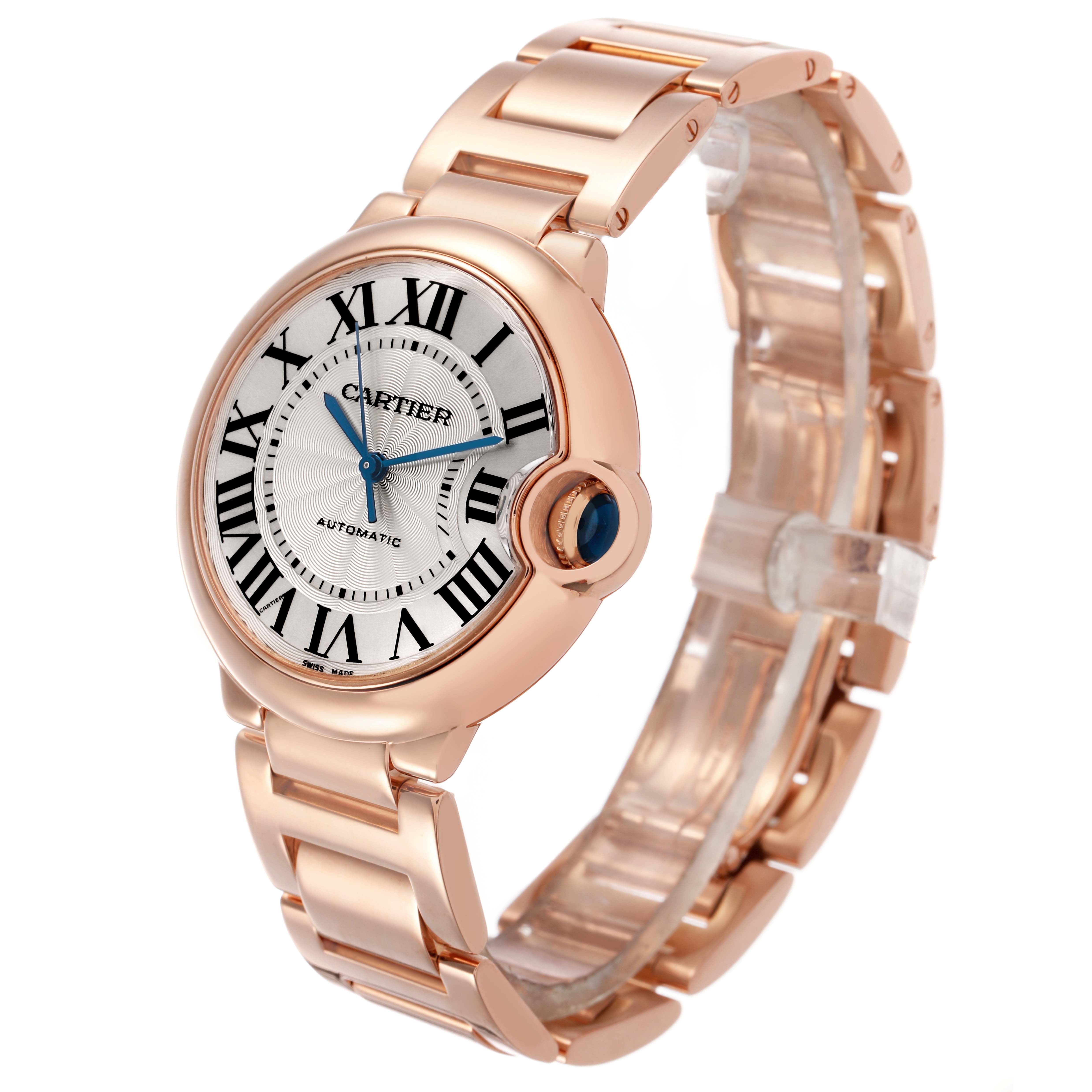 The Cartier Ballon Bleu W69004Z2 Men's Rose Gold Silver Dial watch is shown at a three-quarter angle, displaying its round face, Roman numerals, and metallic bracelet.