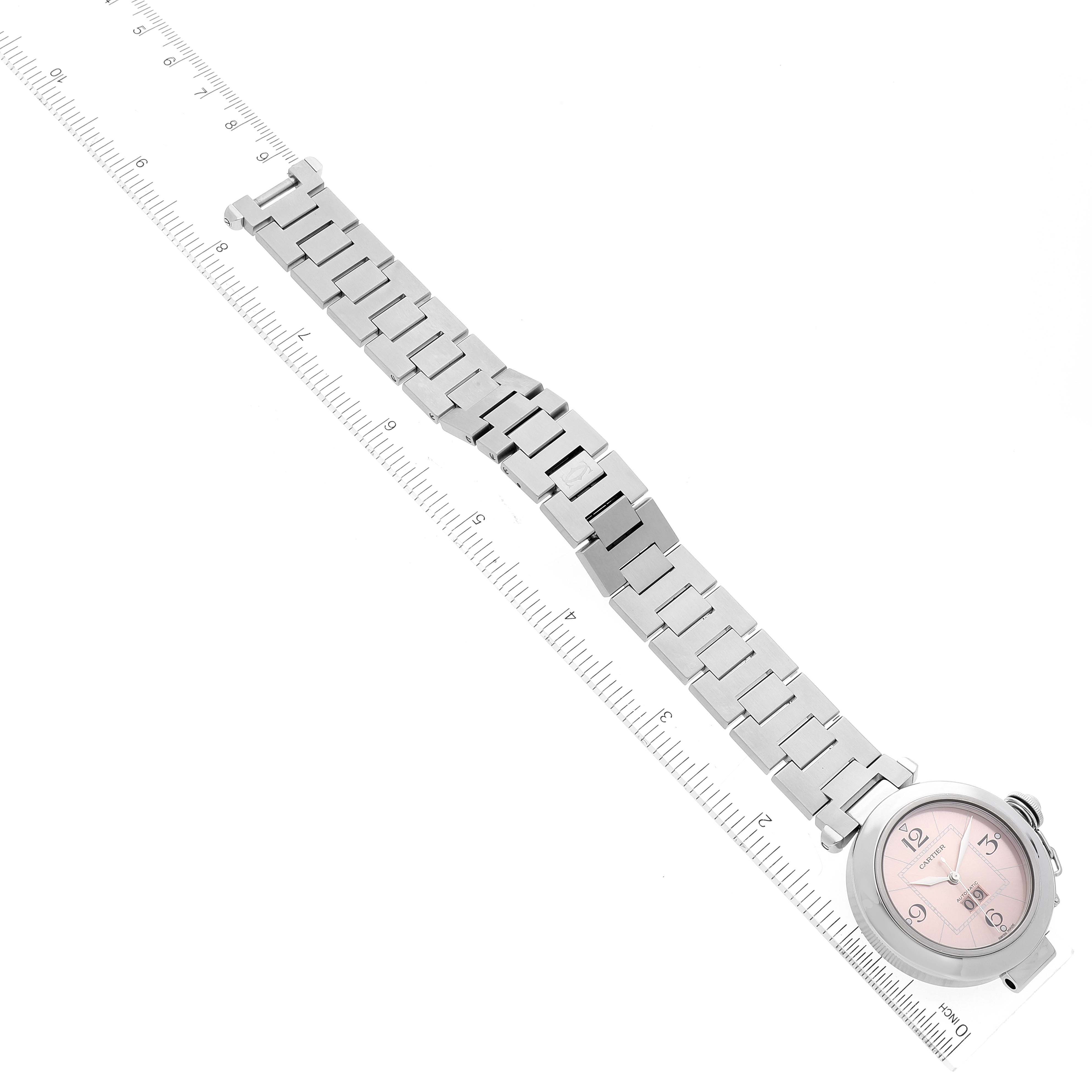 The image shows a Cartier Pasha W31058M7 Women's Stainless Steel Pink Dial W31058M7 Women's Stainless Steel Pink Dial watch laid flat with its full metal bracelet and face visible against a ruler for measurement.