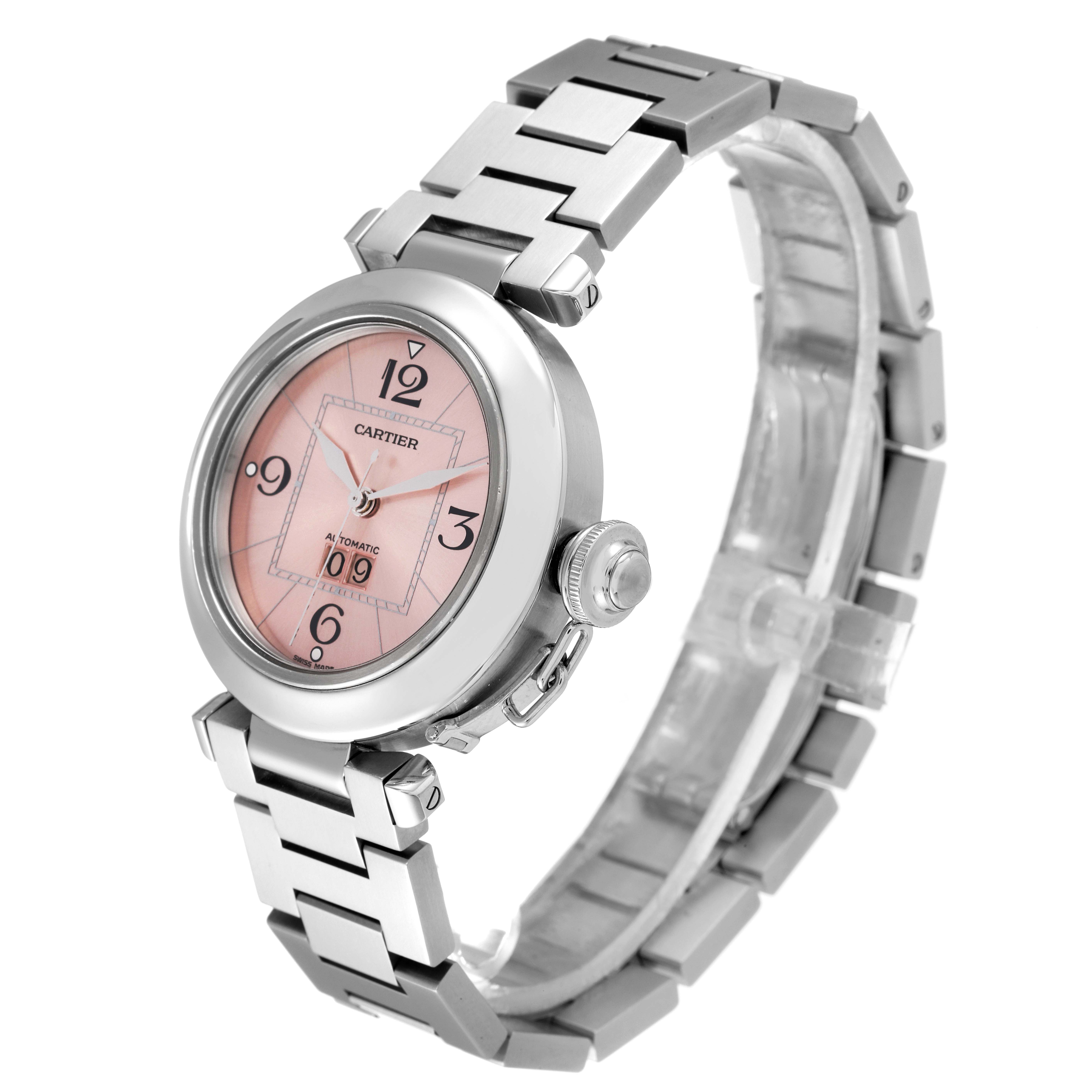 The Cartier Pasha W31058M7 Women's Stainless Steel Pink Dial W31058M7 Women's Stainless Steel Pink Dial watch is shown at an oblique angle, highlighting its pink dial, bezel, crown, and silver bracelet.