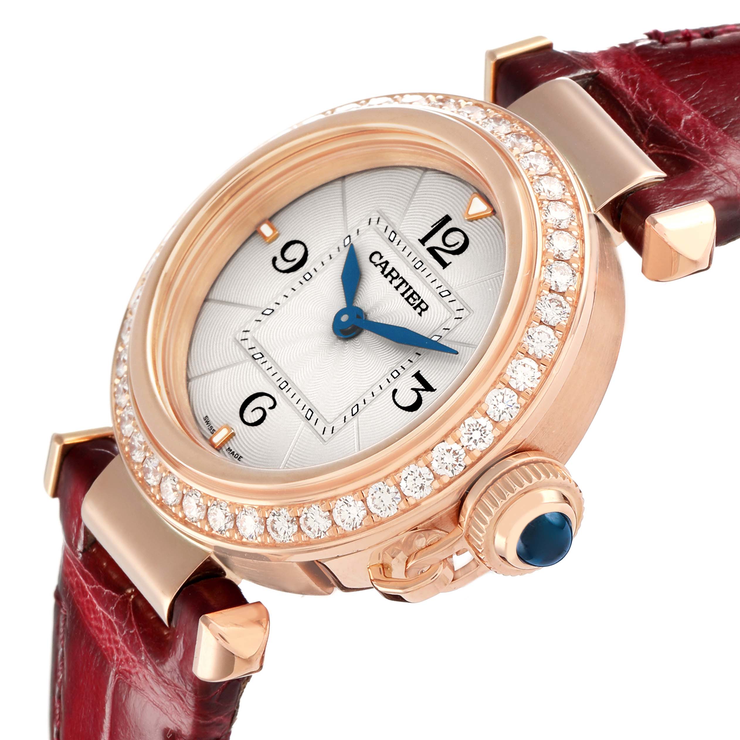 The Cartier Pasha WJPA Women's Rose Gold Silver Dial watch is shown at an angle highlighting the diamond bezel, crown, white dial, and red leather strap.
