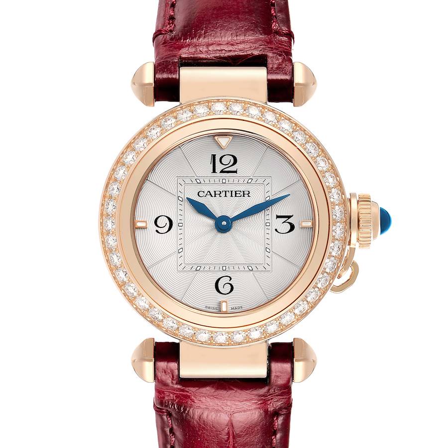 The Cartier Pasha WJPA Women's Rose Gold Silver Dial watch is shown from a top-down angle, displaying the dial, diamond bezel, blue crown, and red strap.