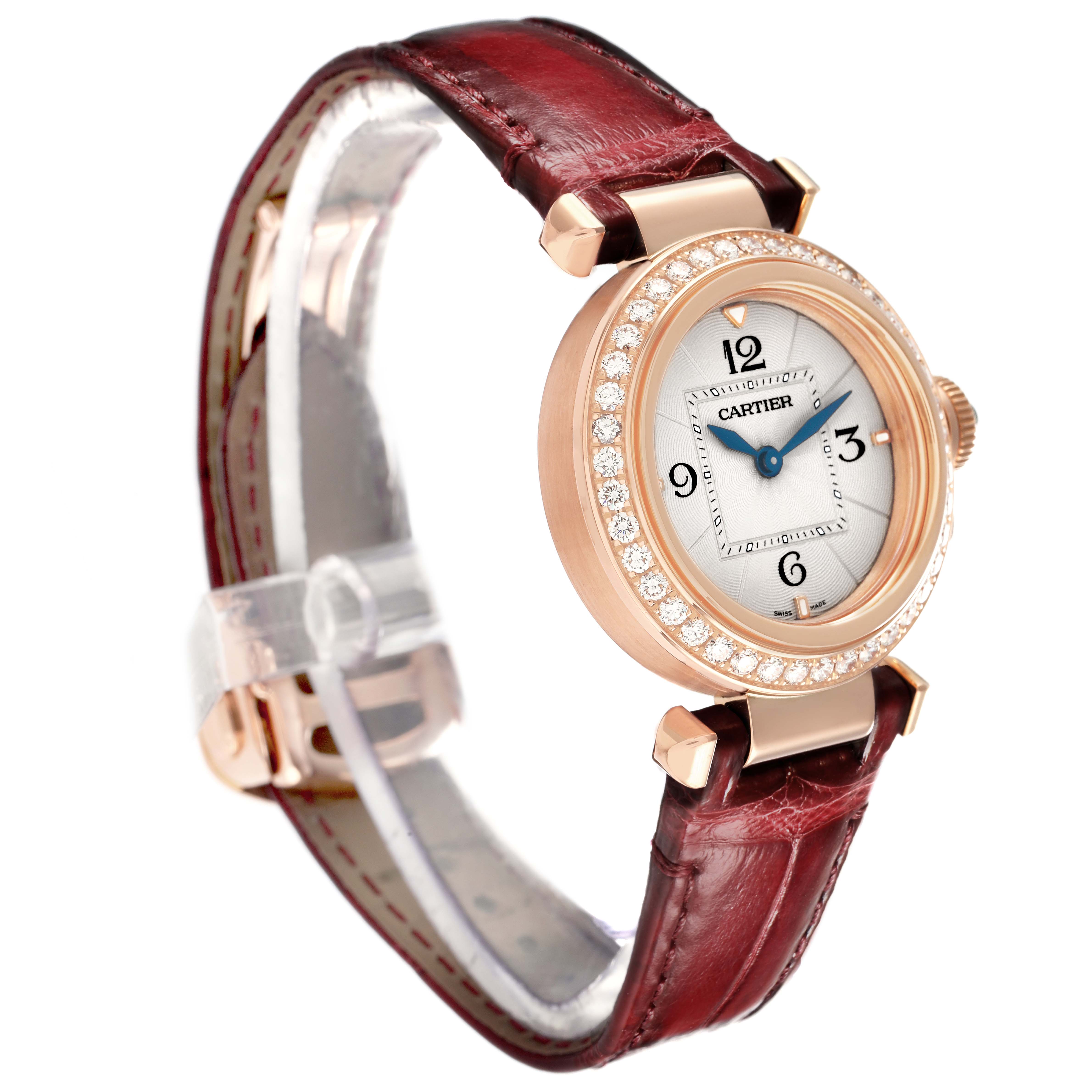 The Cartier Pasha WJPA Women's Rose Gold Silver Dial watch is shown at an angled view, highlighting its diamond bezel, numerals, and leather strap.
