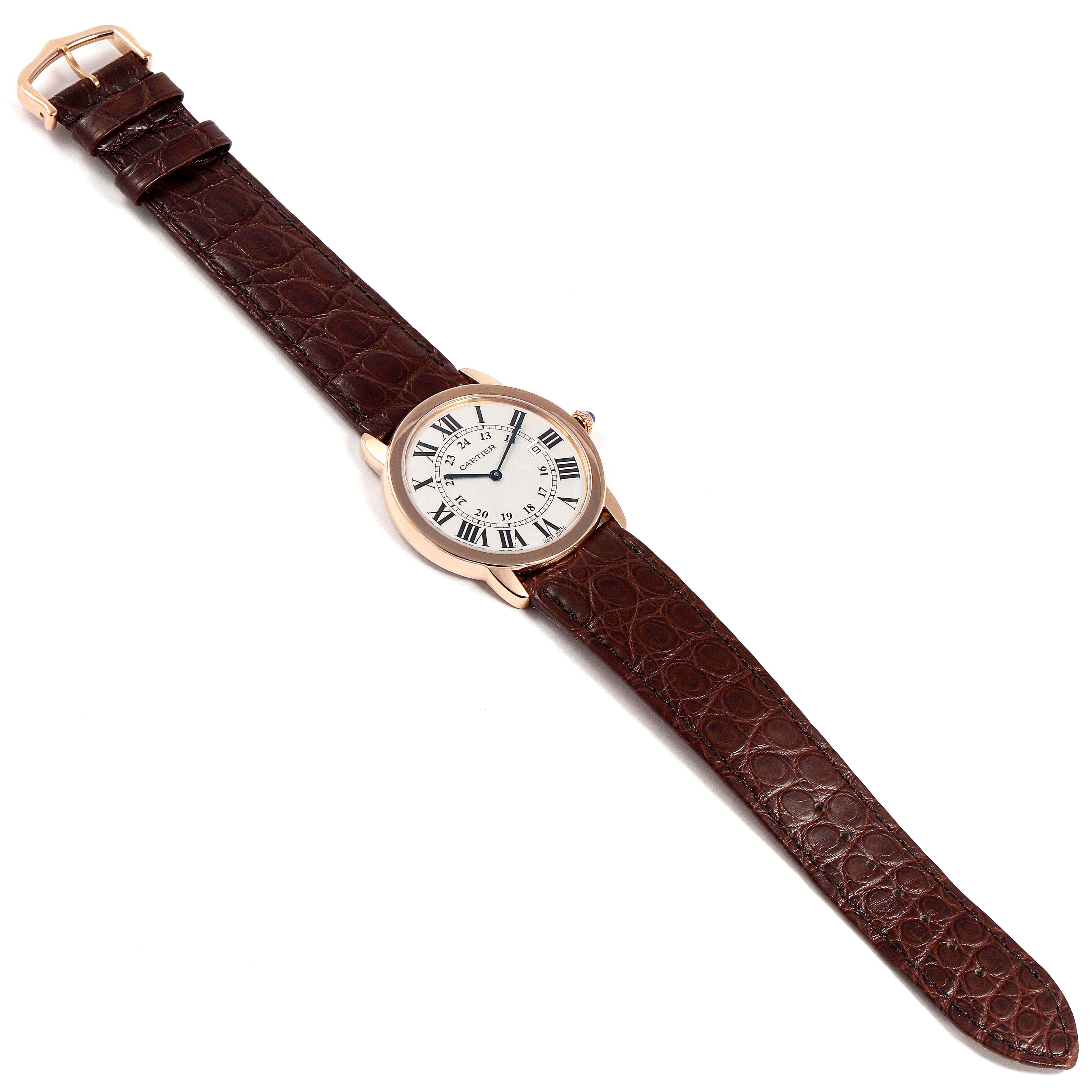The Cartier Ronde W6701008 Men's Rose Gold Silver Dial W6701008 Men's Rose Gold Silver Dial watch is shown from a top-down angle, displaying the full watch face and its brown leather strap.