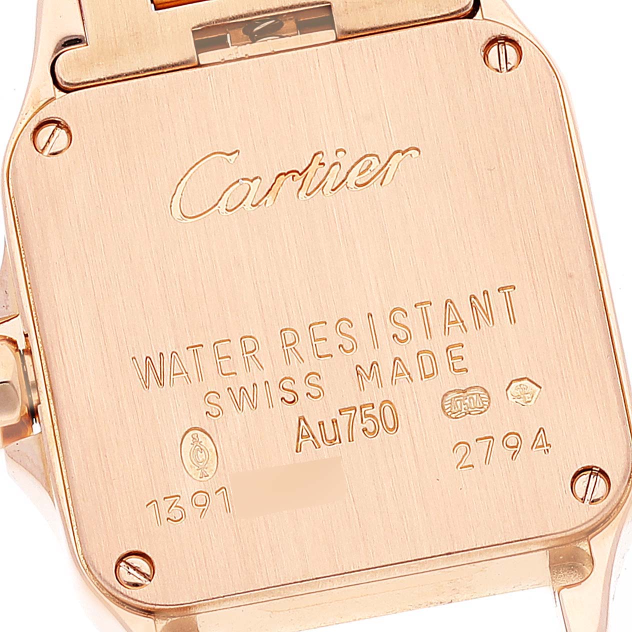 The image shows the back case of a Cartier Santos Demoiselle WF9011Z8 Women's Rose Gold Silver Dial WF9011Z8 Women's Rose Gold Silver Dial watch, highlighting brand engravings and specifications.