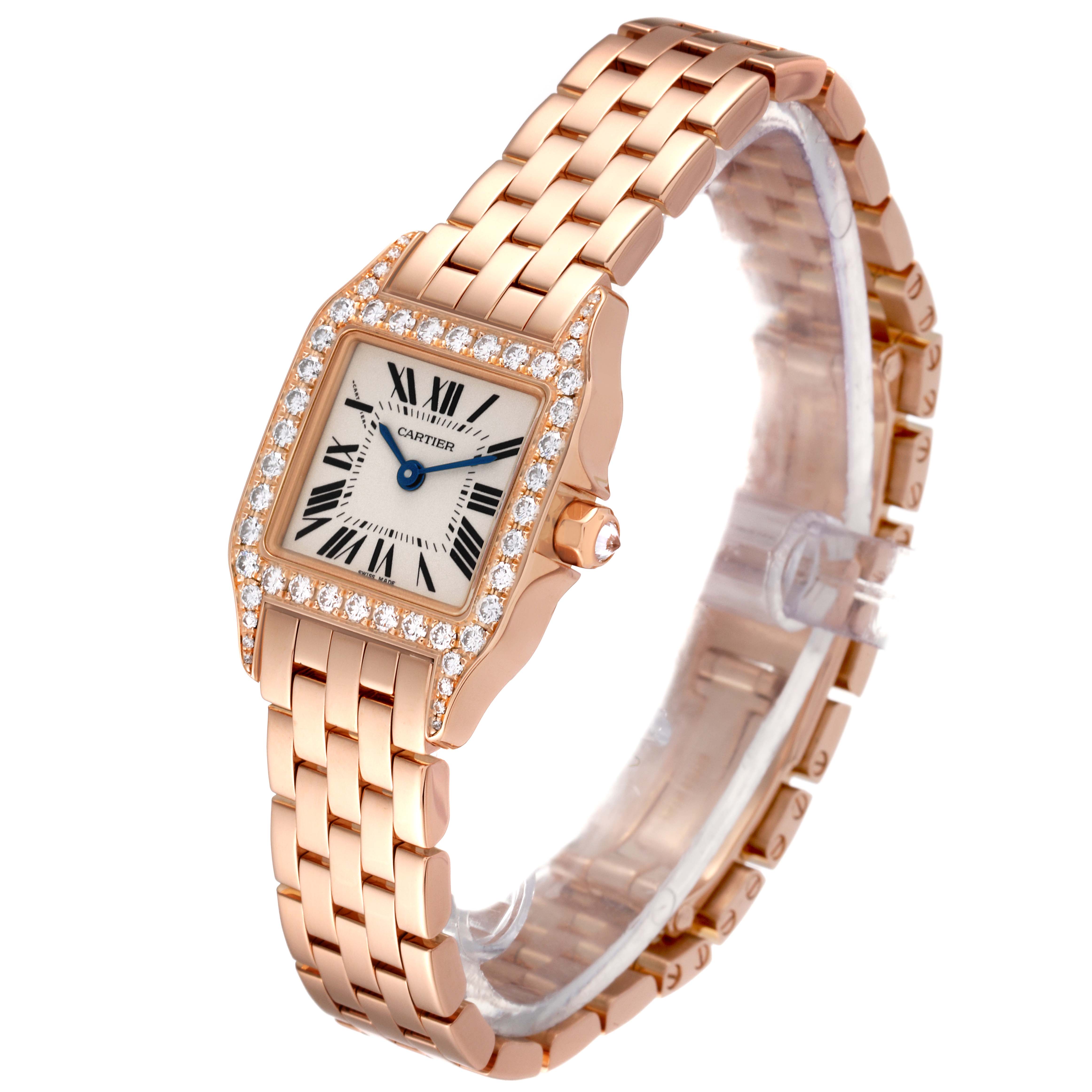The Cartier Santos Demoiselle WF9011Z8 Women's Rose Gold Silver Dial WF9011Z8 Women's Rose Gold Silver Dial watch is shown at an angled view, displaying its face, bracelet, and diamond-encrusted bezel.