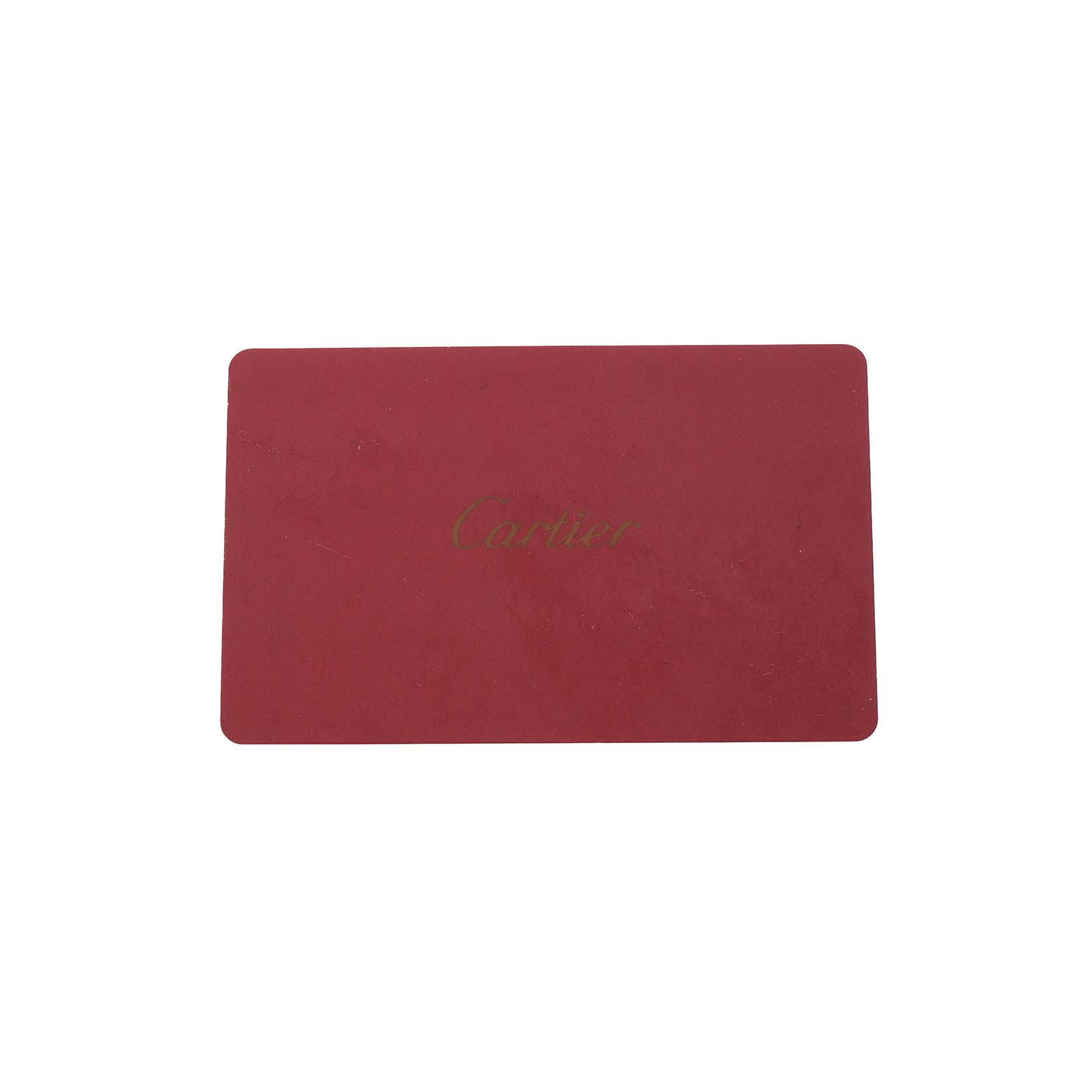 The image shows a red rectangular card with "Cartier" written on it, likely an accessory for the Cartier Tank Americaine W2607456 Women's Rose Gold Silver Dial watch.