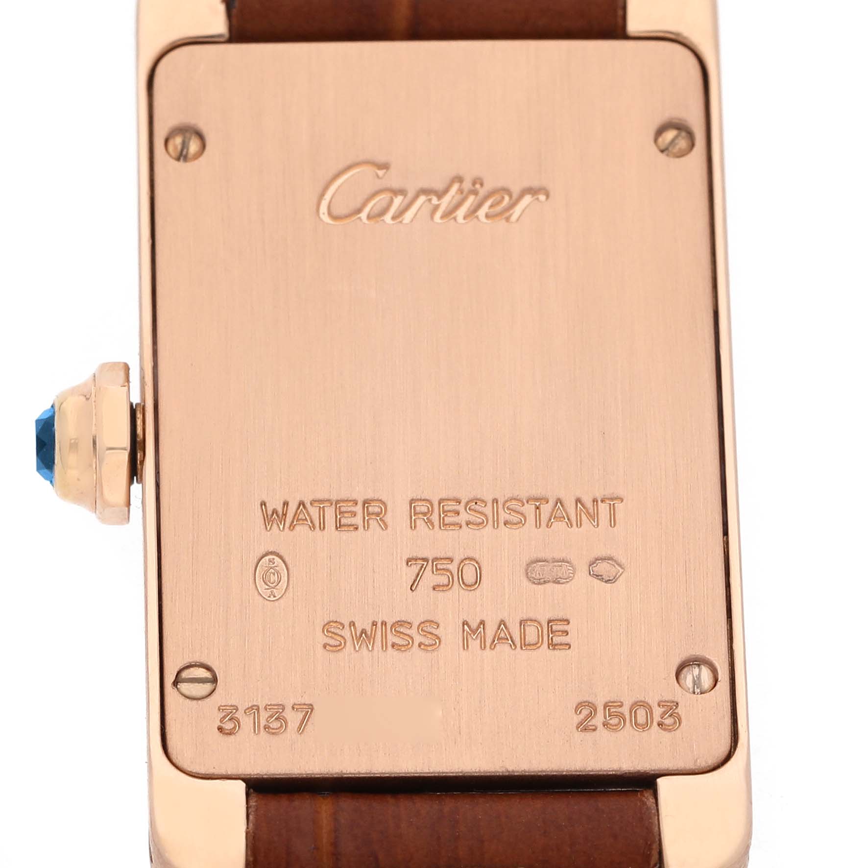 The image shows the back of the Cartier Tank Americaine W2607456 Women's Rose Gold Silver Dial watch with engravings and part of the strap.