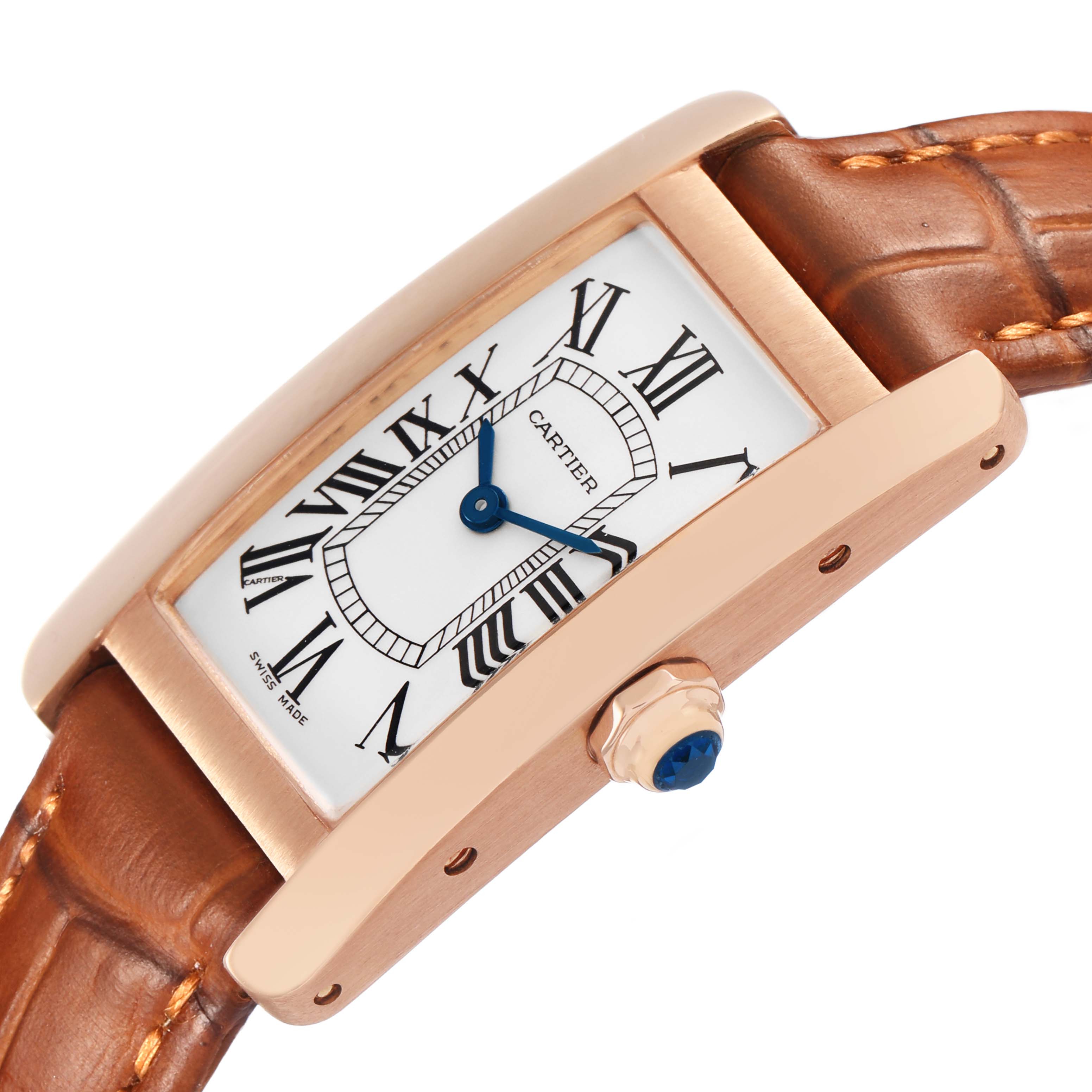 The Cartier Tank Américaine watch is shown at an angled side view, displaying the face, crown, and leather strap.