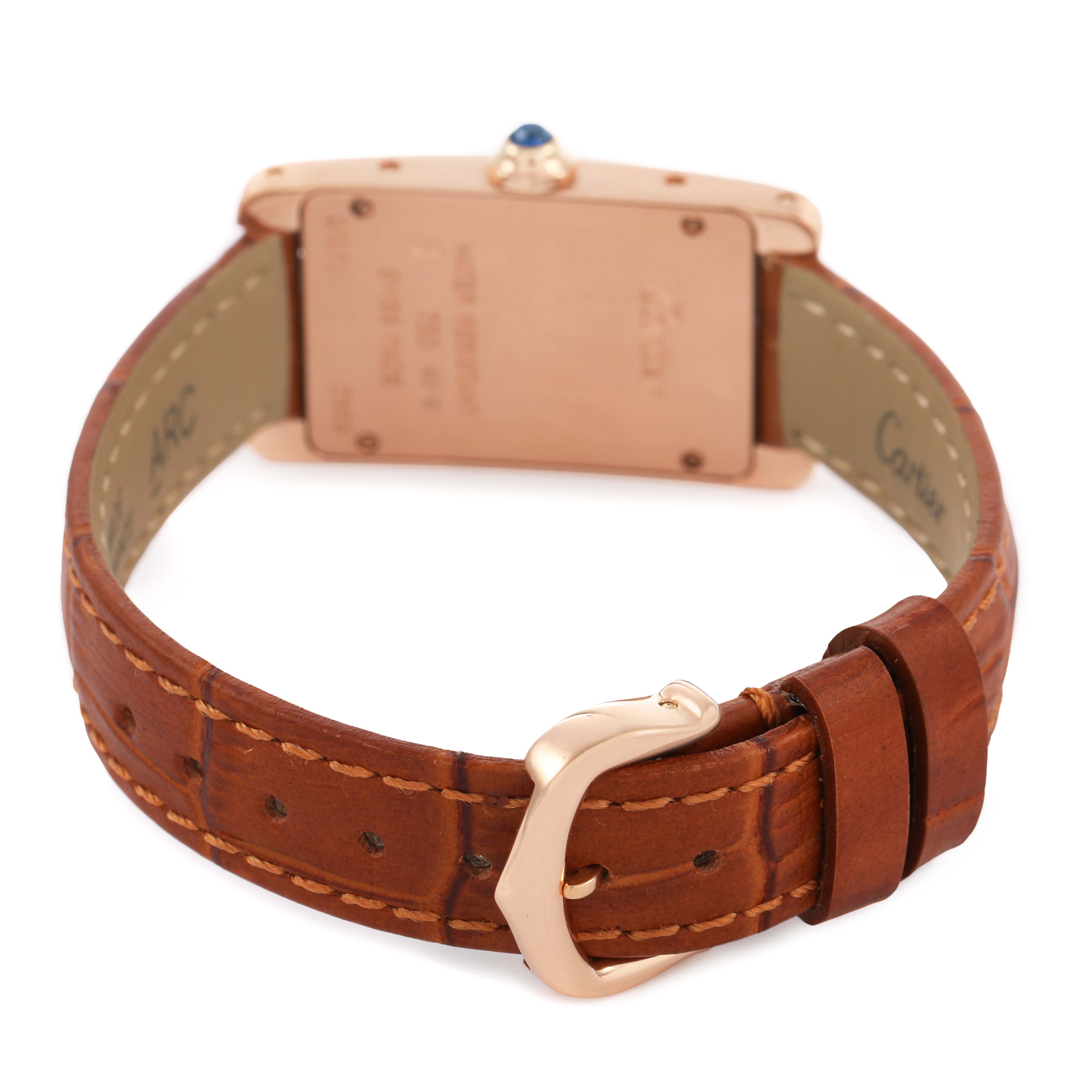 The Cartier Tank Americaine W2607456 Women's Rose Gold Silver Dial watch is shown from the back, highlighting the case back, crown, and brown leather strap with buckle.