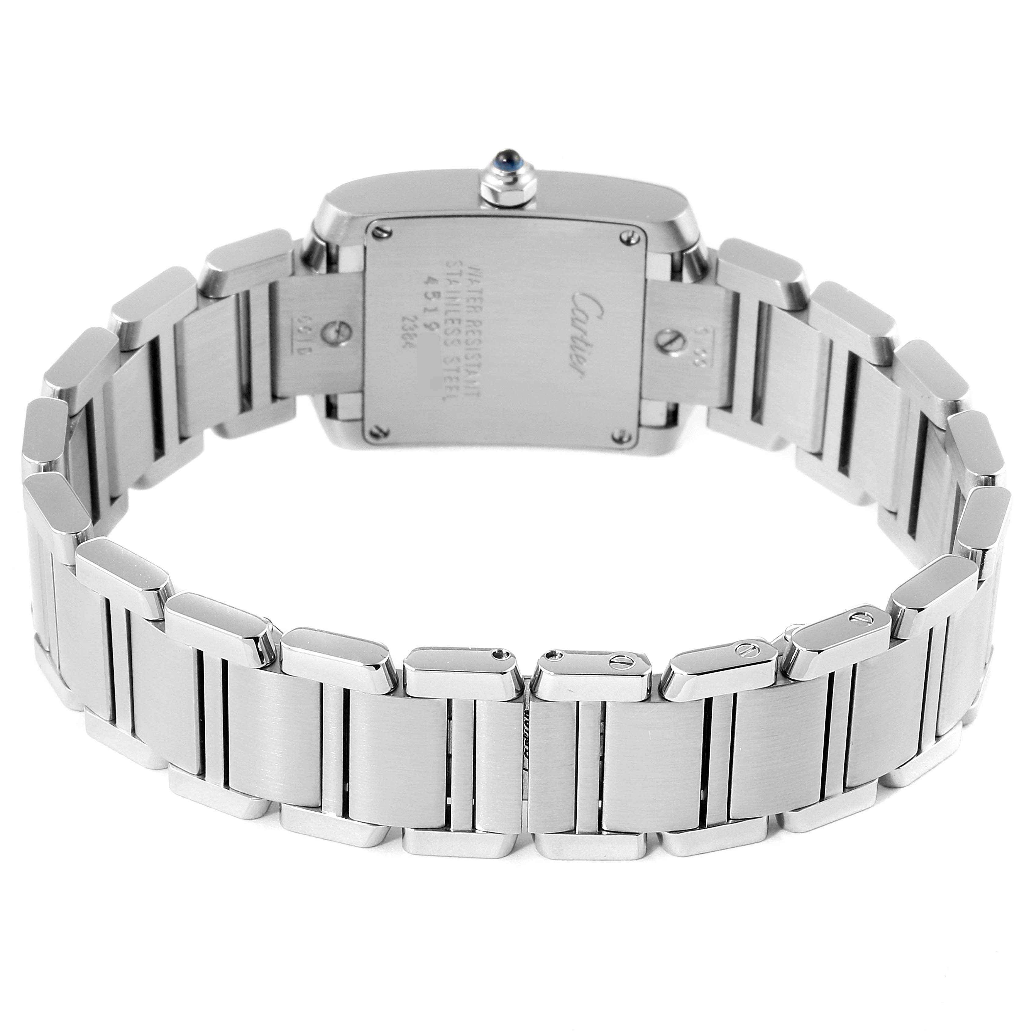 The image shows the back view of a Cartier Tank Française watch, highlighting the case back and stainless steel bracelet.
