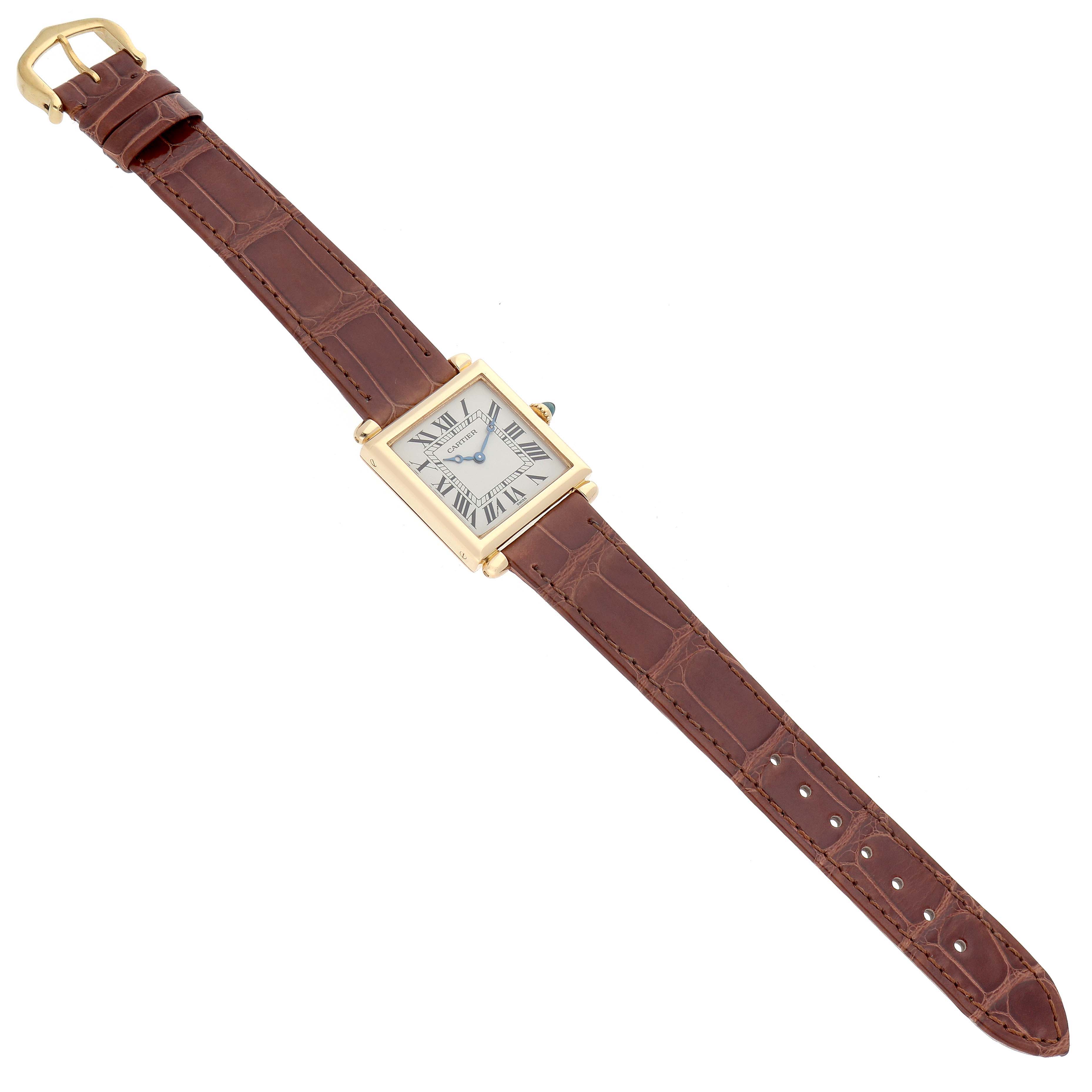 The Cartier Tank Obus W1512256 Women's Yellow Gold Silver Dial watch is shown from an angled top view, displaying the face, strap, and buckle.