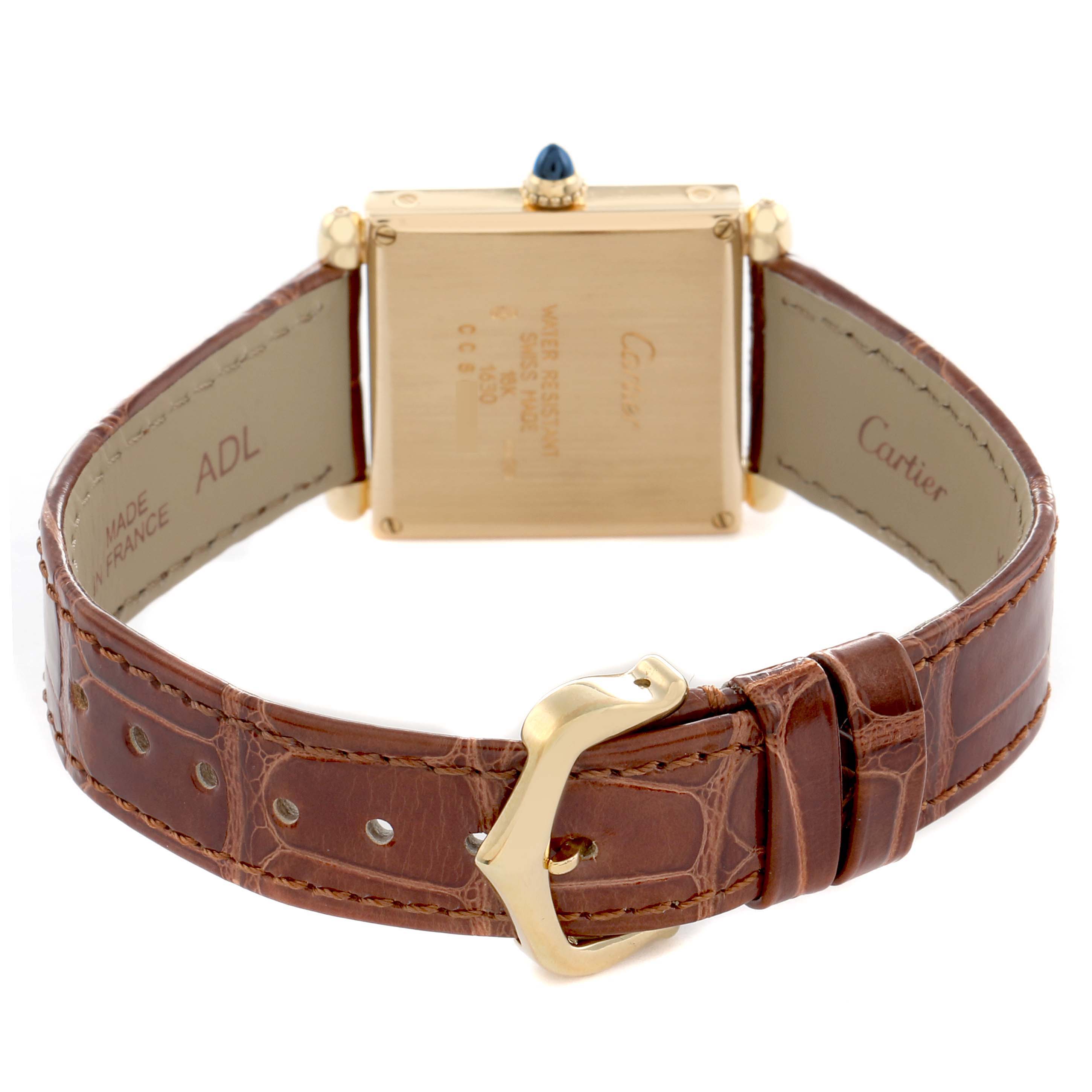 The Cartier Tank Obus W1512256 Women's Yellow Gold Silver Dial watch is shown from the back, displaying its case back, crown, and brown leather strap with buckle.