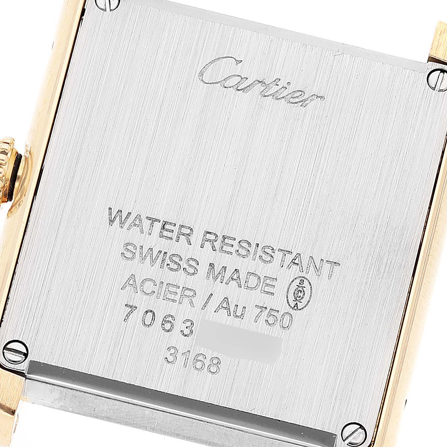The image shows the back case of a Cartier Tank Solo W5200002 Women's Yellow Gold Silver Dial W5200002 Women's Yellow Gold Silver Dial watch, highlighting its engraving and screws.
