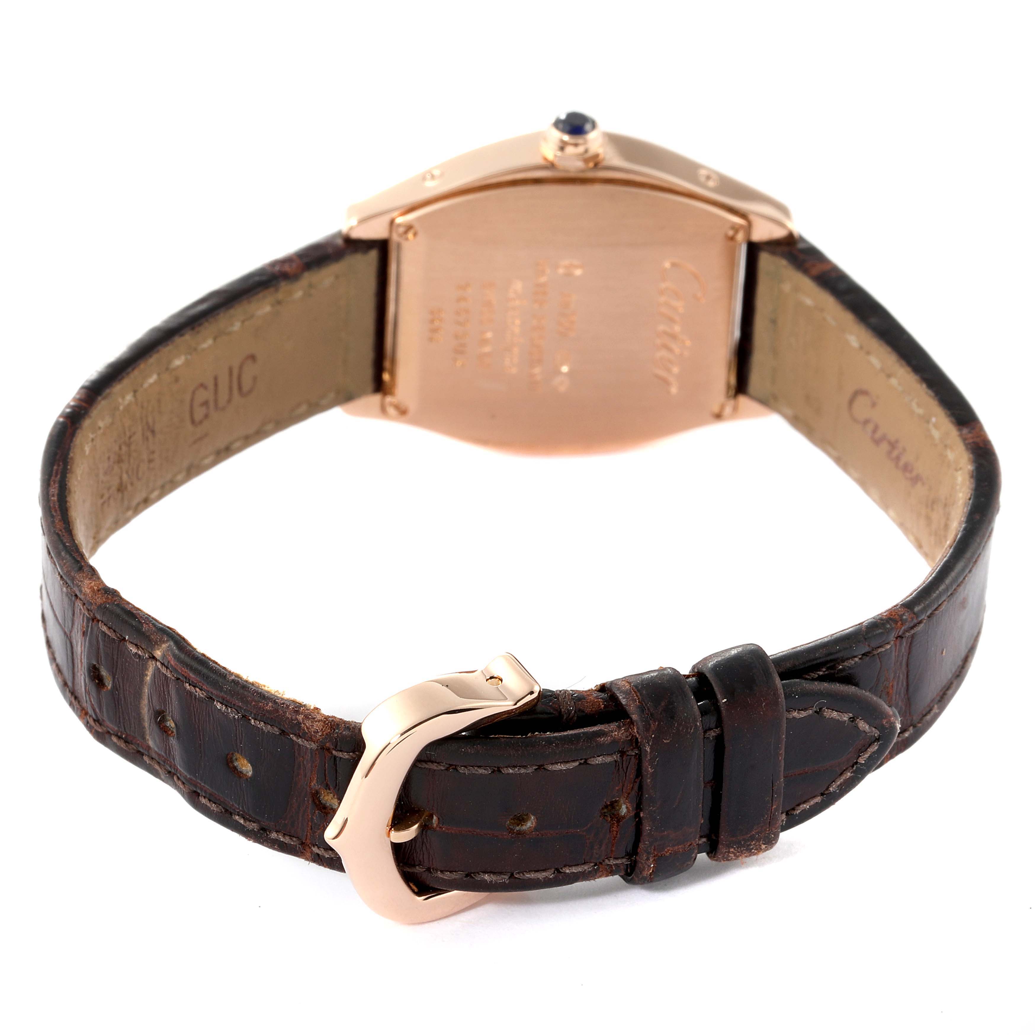 The image showcases the back of the Tortue model by Cartier, displaying the strap and buckle.