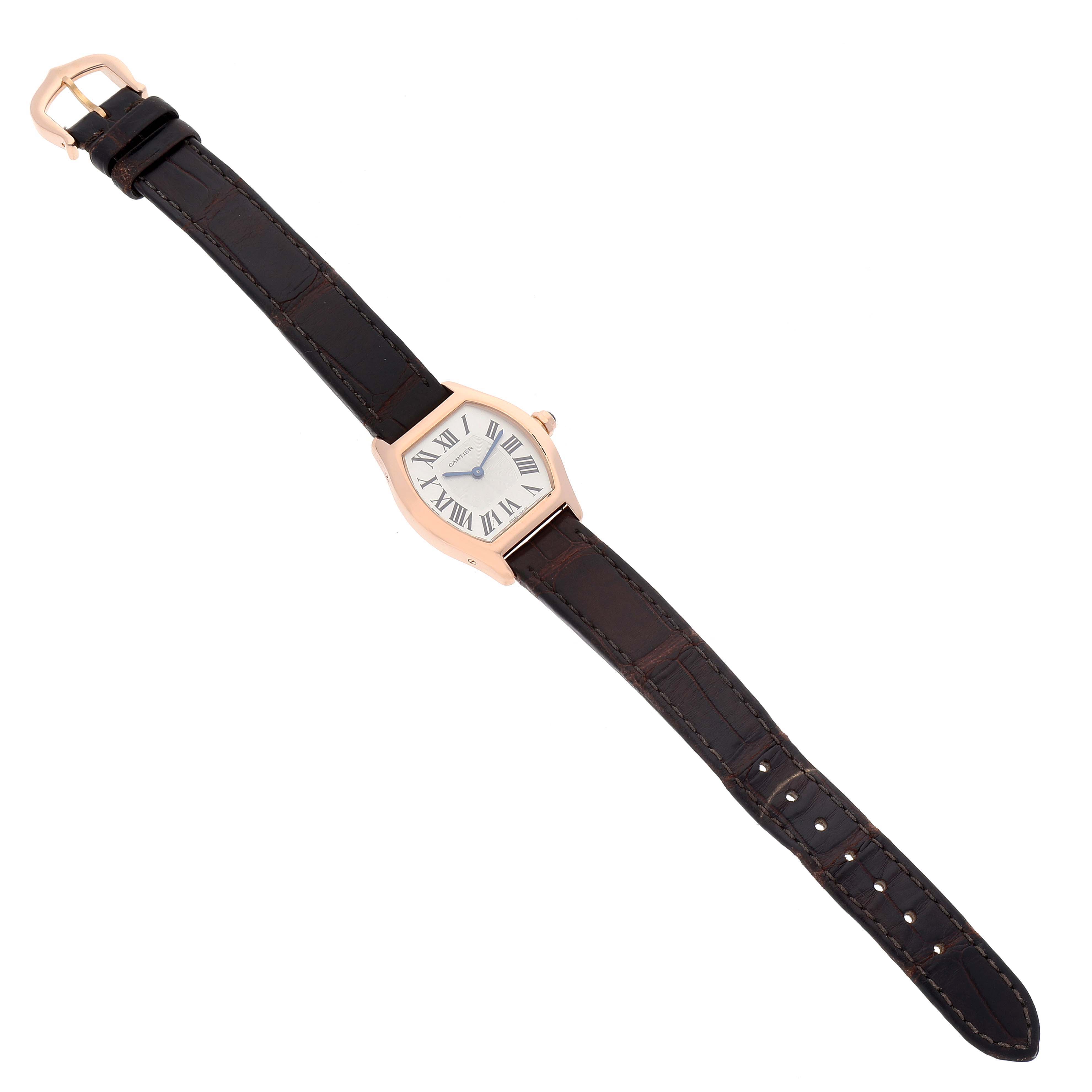 The Cartier Tortue W1556360 Women's Rose Gold Silver Dial W1556360 Women's Rose Gold Silver Dial watch is shown from an overhead angle displaying the face, case, and full leather strap.