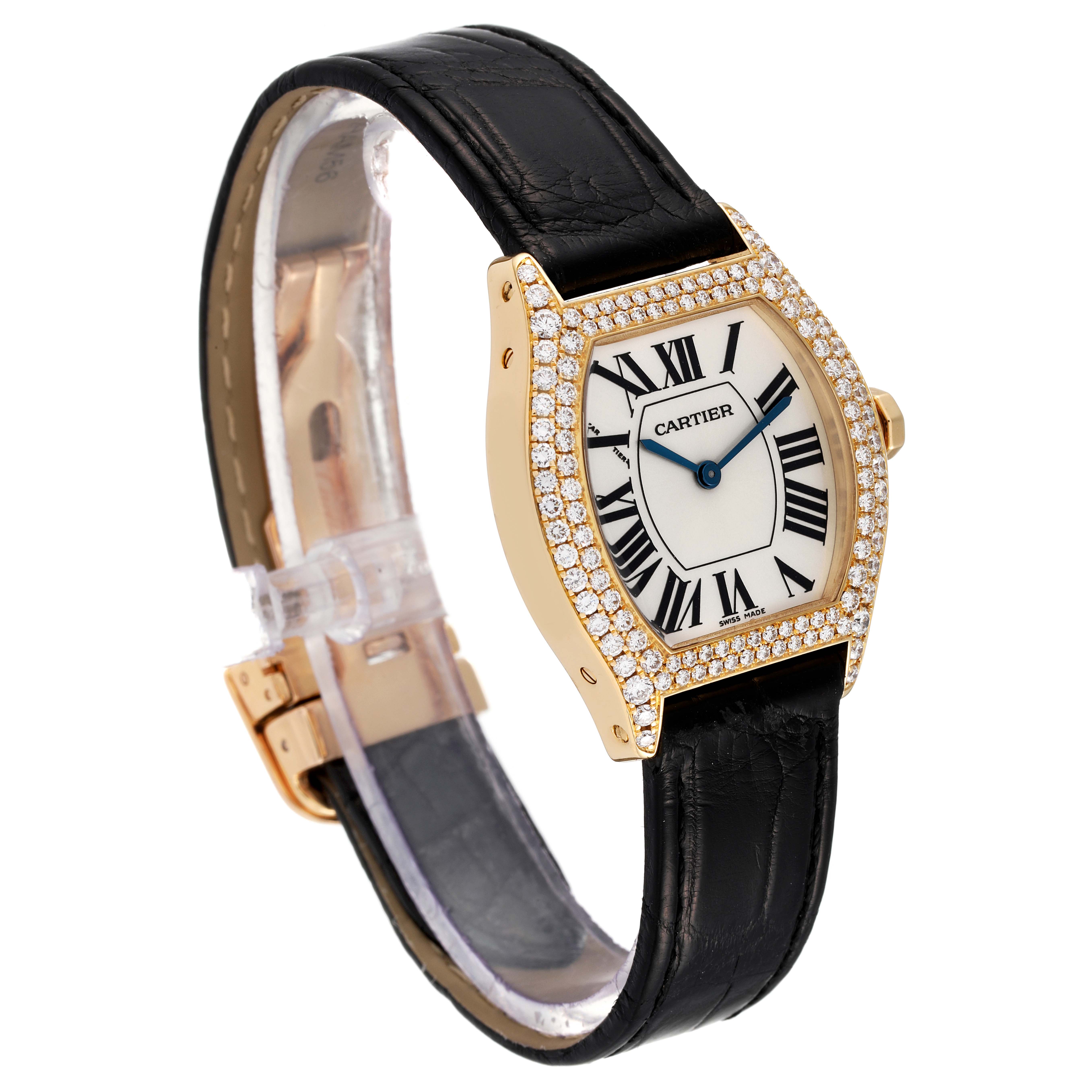 This image shows a Cartier Tortue 2643 Women's Yellow Gold Silver Dial 2643 Women's Yellow Gold Silver Dial watch from a three-quarter angle, displaying its face, strap, and diamond-studded bezel.