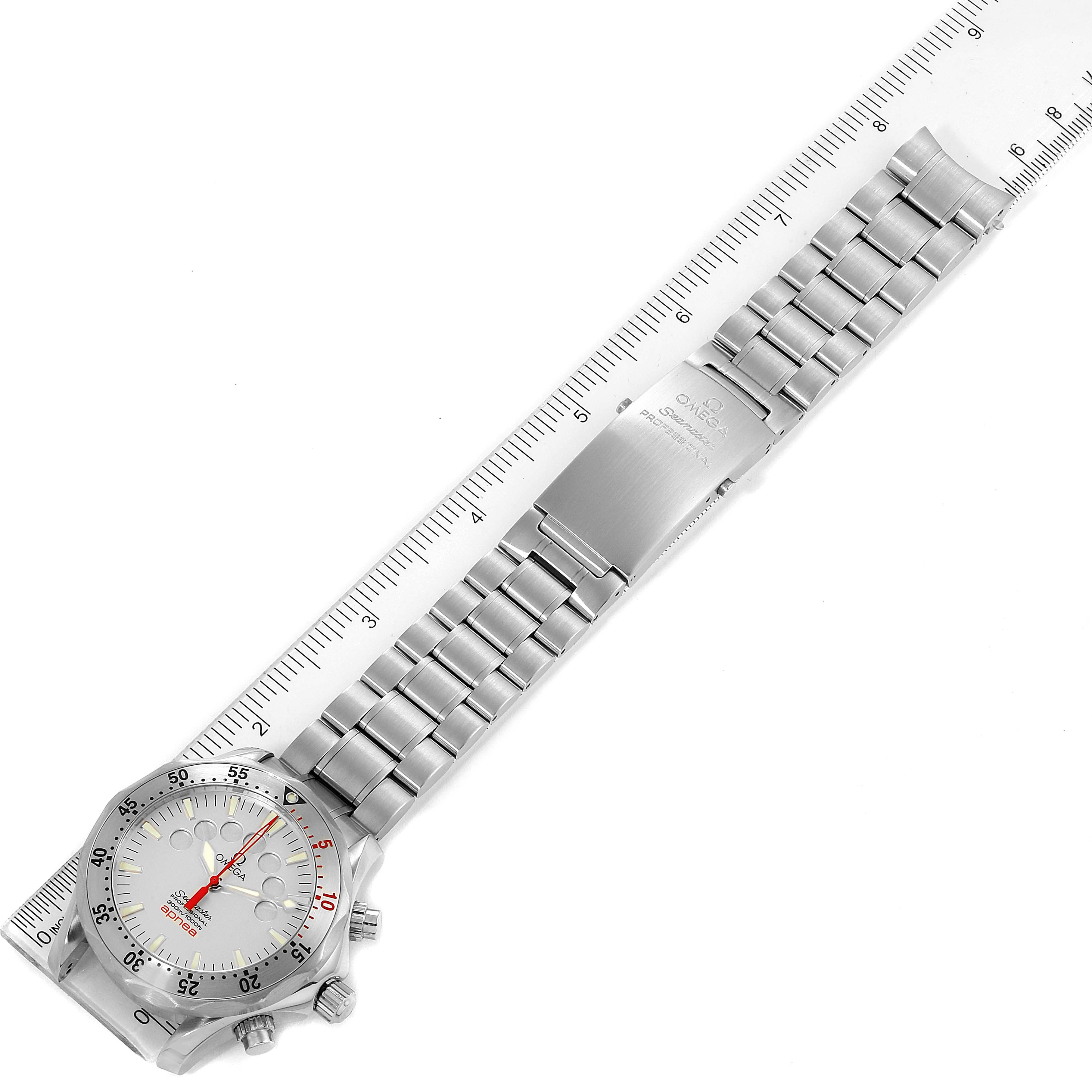 The Omega Seamaster 2595.30.00 Men's Stainless Steel Silver Dial 2595.30.00 Men's Stainless Steel Silver Dial watch is shown in a top-down view with its face, bezel, crown, and full bracelet visible, placed on a ruler.