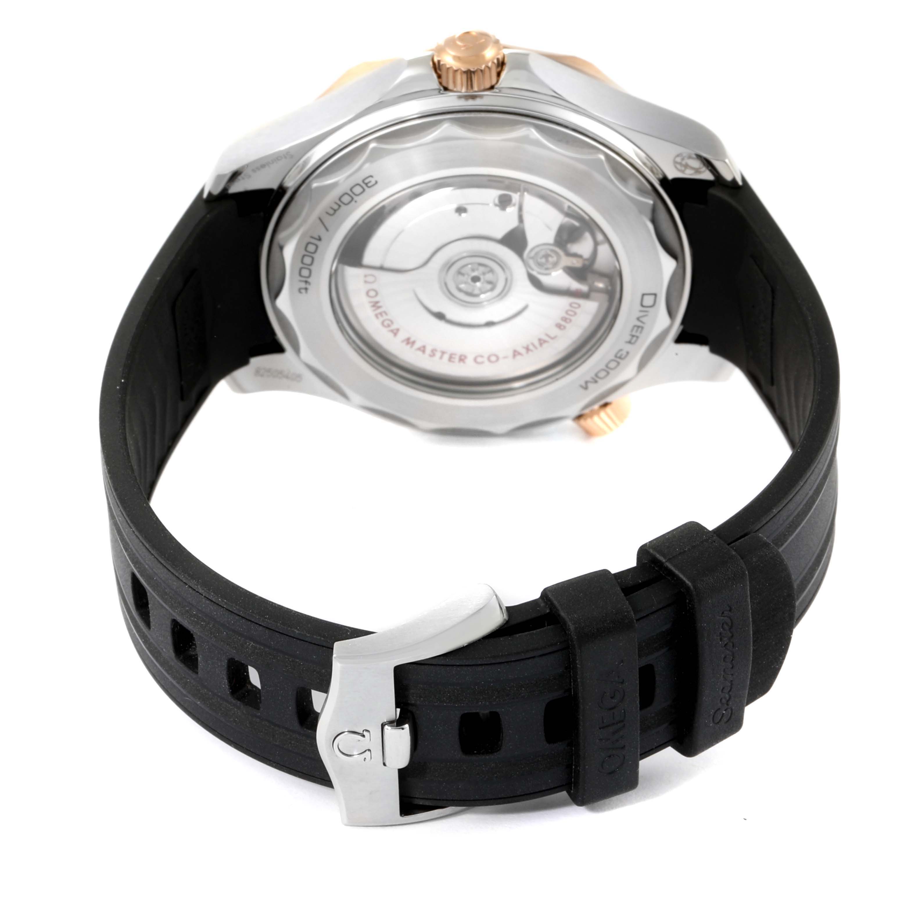 The Omega Seamaster 210.22.42.20.01.002 Men's Steel and Gold (two tone) Black Dial 210.22.42.20.01.002 Men's Steel and Gold (two tone) Black Dial watch is shown from the back, highlighting its case back, movement, and rubber strap.